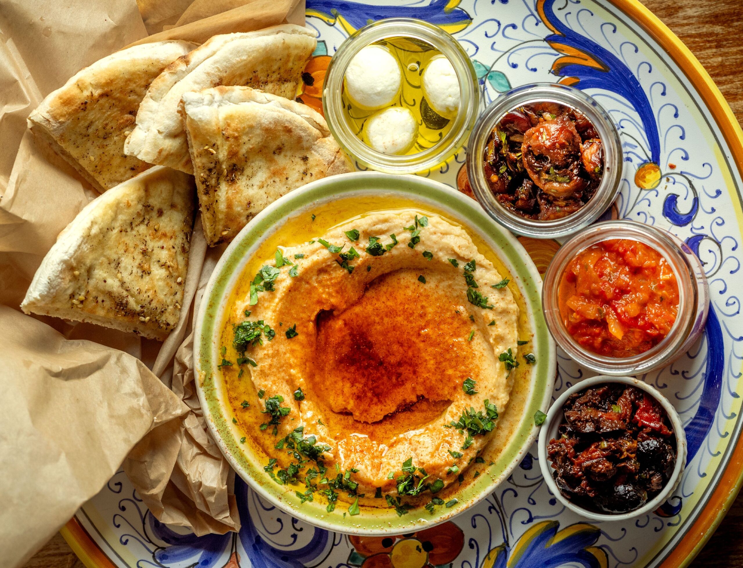 Meza Plate with Pita, hummus, red pepper matbucha, caramelized eggplant, pomegranate molasses, garlic, olives and labne at the Sonoma Wine Shop/La Bodega Kitchen Thursday, Nov. 13, 2025 in Sebastopol. (John Burgess / The Press Democrat)