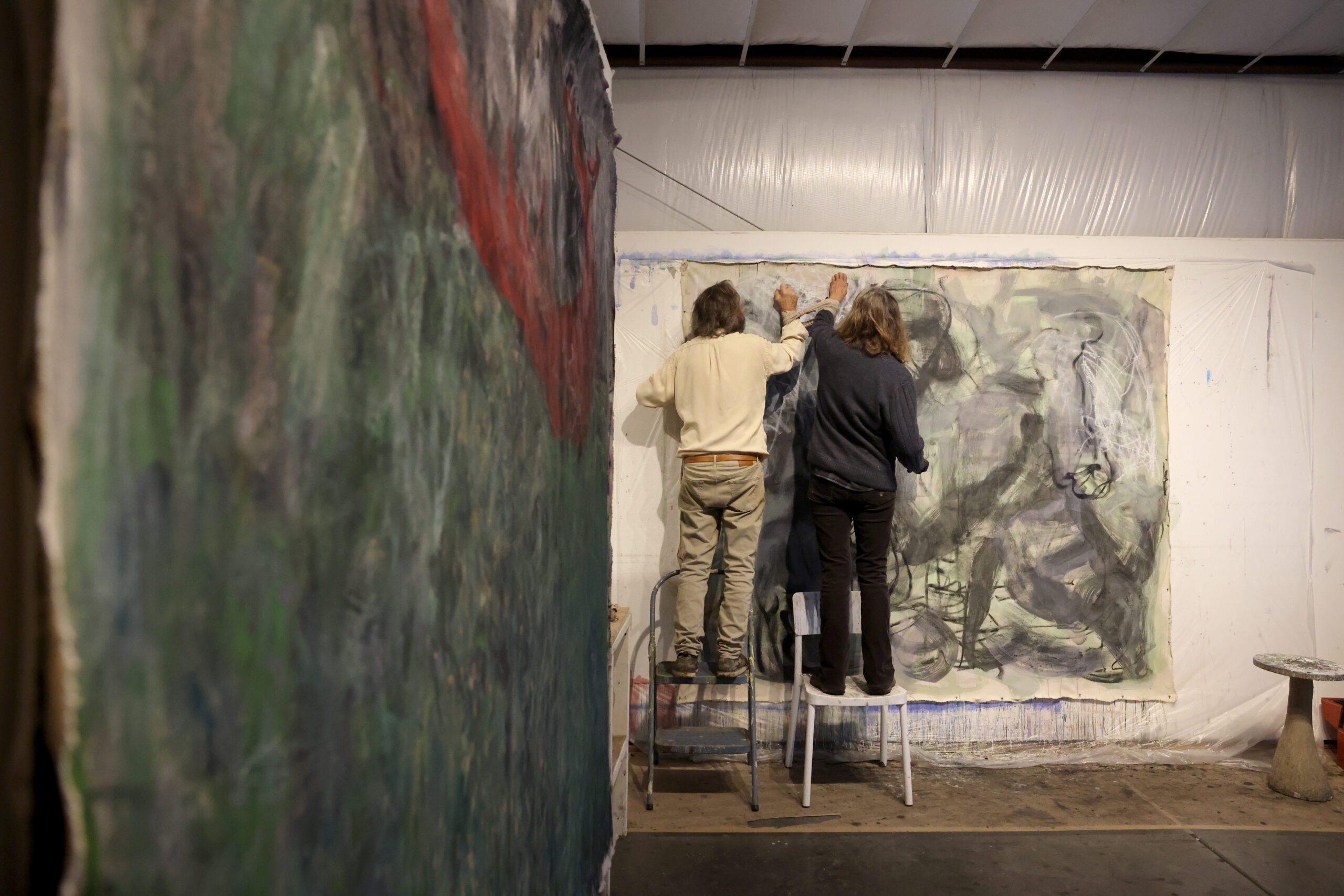 Artists Pamela Holmes and Winston Gourley paint with their arms bound together at their art studio