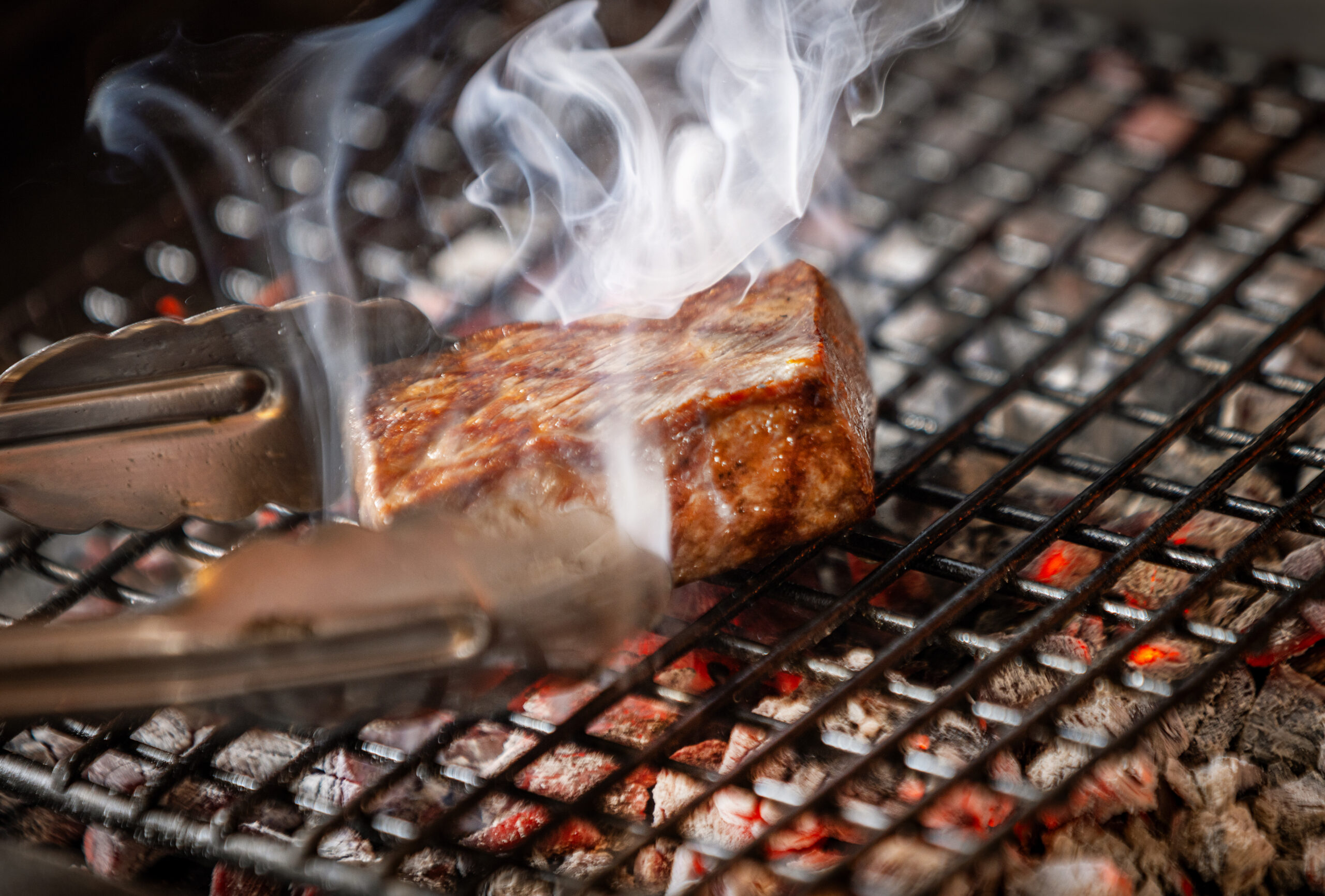 Alex Fuentes, Head Chef of Special Projects, sears the Knights Valley Wagyu over coals at SingleThread in Healdsburg, Sept. 19, 2025. (John Burgess / The Press Democrat)