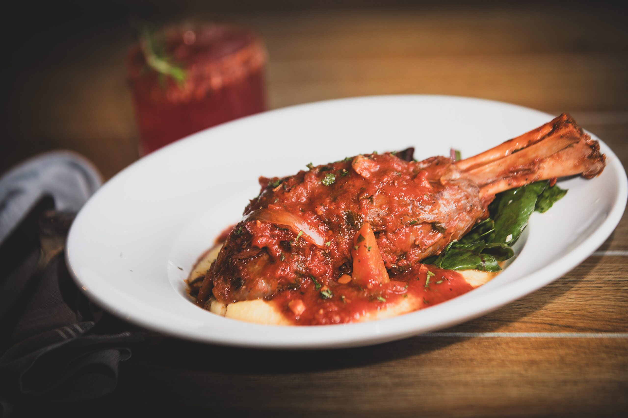 Zinfandel Braised Lamb Shank with Polenta and Greens and a Wintergreen Margarita from Catelli’s Restaurant Sunday, Dec. 21, 2025, in Geyserville. (John Burgess / The Press Democrat)