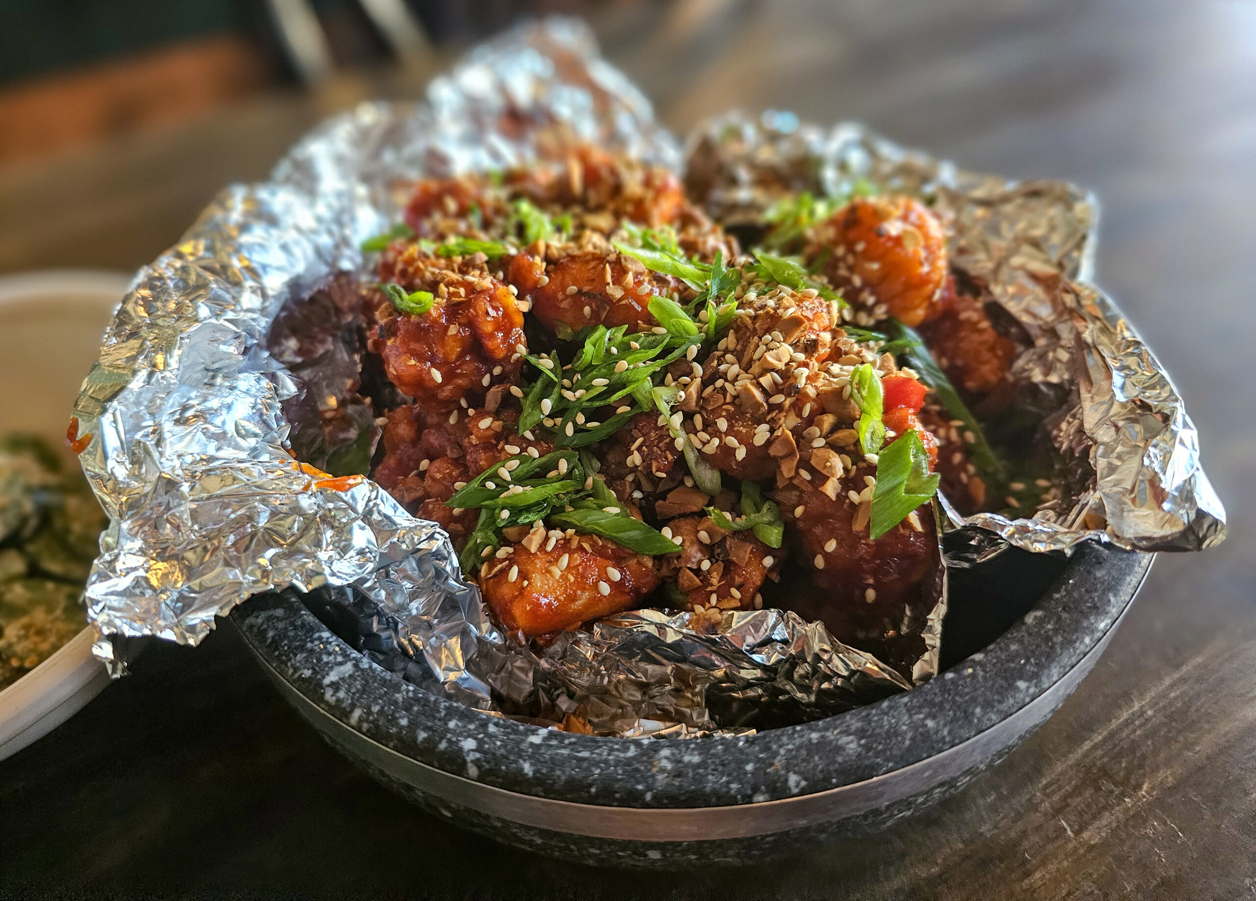 Spicy fried chicken with fried peanuts at Bazaar Sonoma's Korean pop-up preview. (Heather Irwin / The Press Democrat)