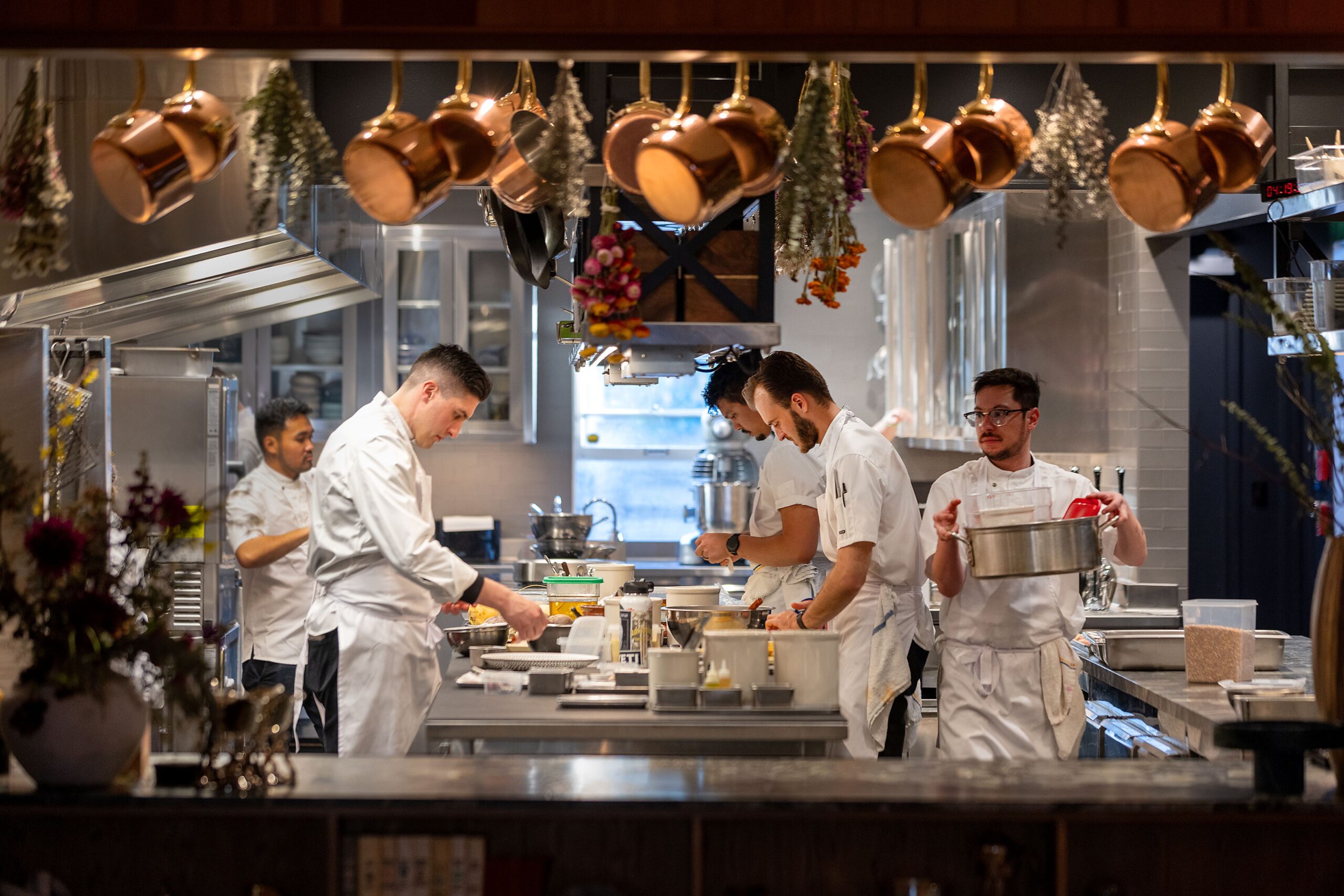 Chef Brian Limoges, left, and his staff are on display for guests in the cedar-lined dining room at Enclos in Sonoma, Thursday, Jan. 16, 2025. (John Burgess / The Press Democrat)