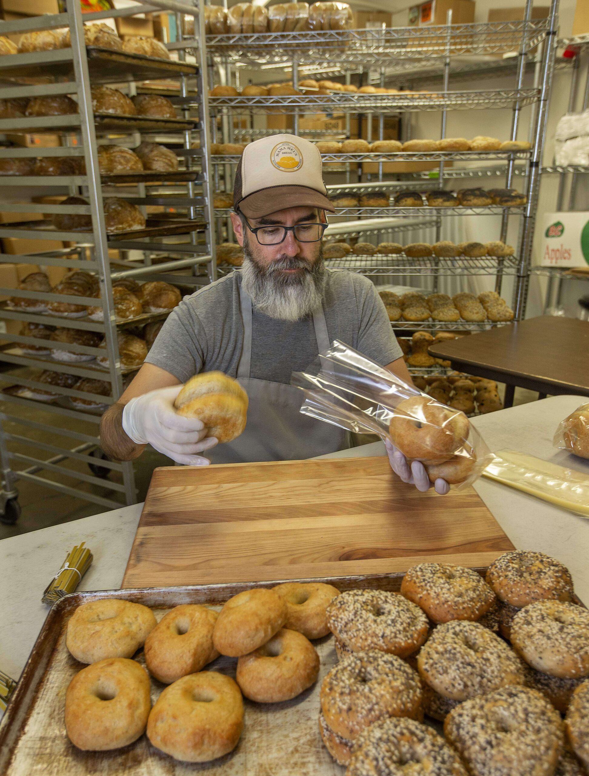 Thomas James packages fresh baked gluten-free bagels at Mama Mel's Bread in Petaluma