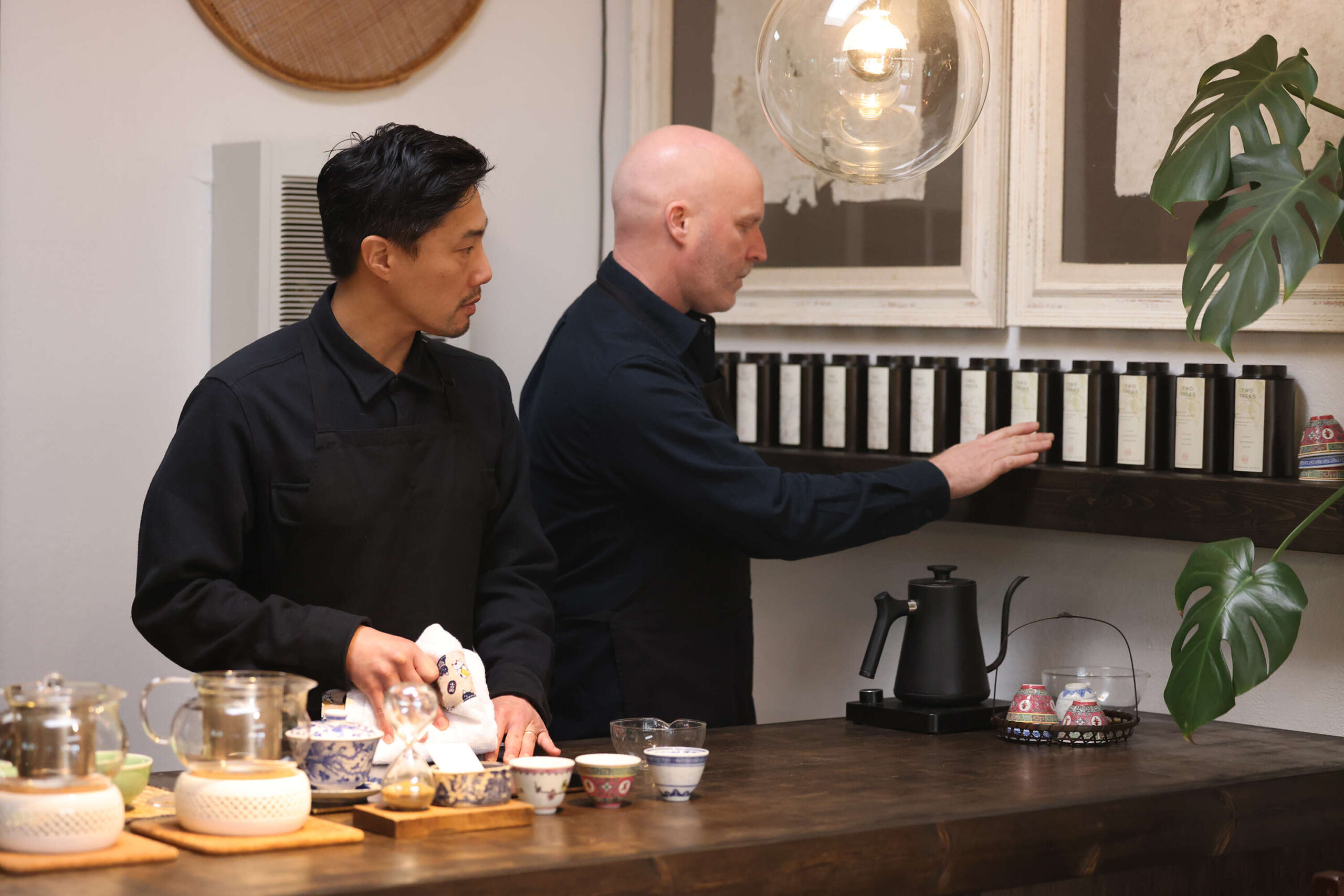 Owners Adrian Chang, left, and his husband Chris Lewis make tea at Two Trees Tea House in Occidental Wednesday, Feb. 12, 2025. (Beth Schlanker / The Press Democrat)