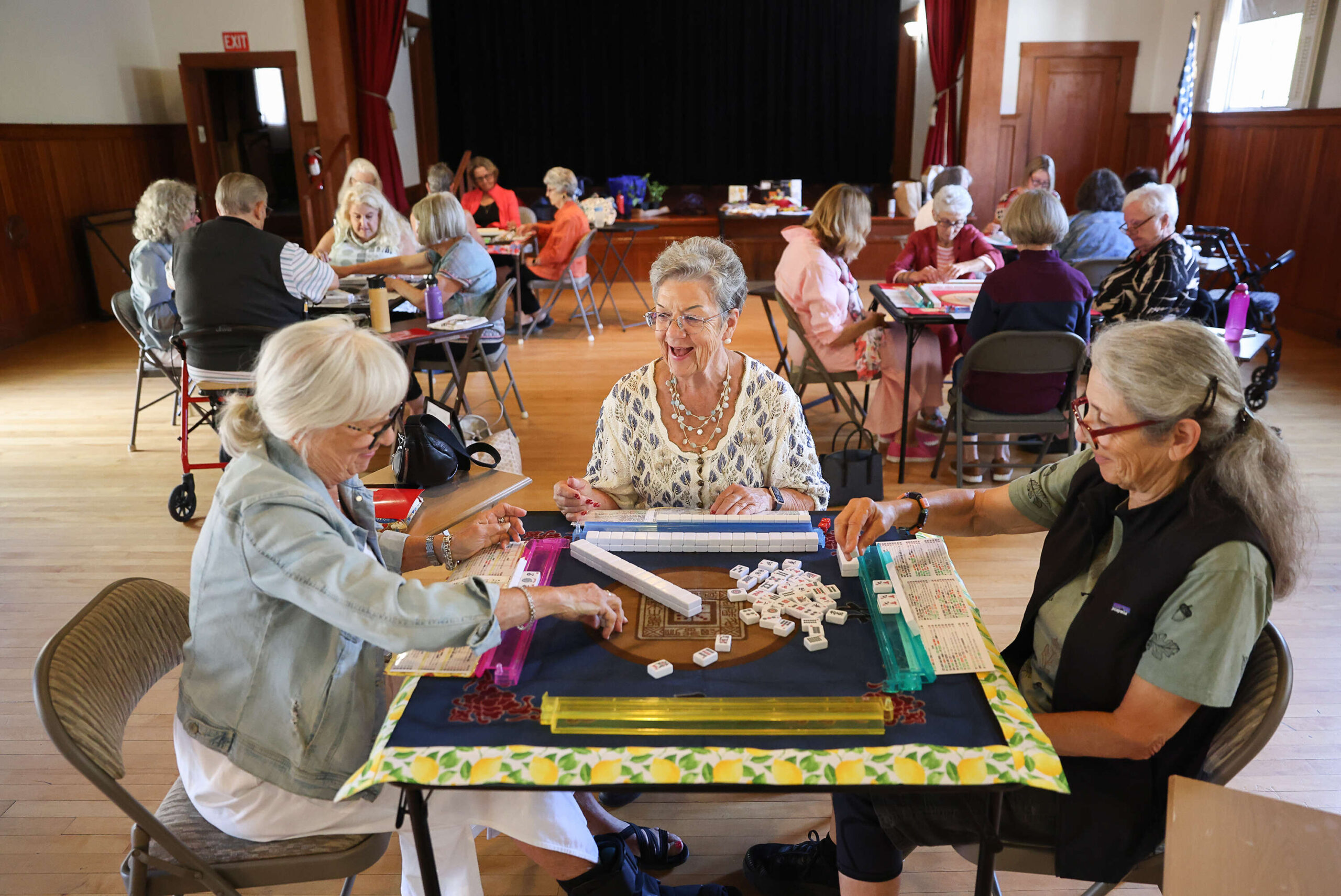 Mahjong teacher Laurie Sebesta, center, laughs while playing a game of American mahjong with Lu Marshall, left, and Sandy Strassberg at the Sonoma Valley Woman’s Club in Sonoma on Wednesday, July 23, 2025. (Christopher Chung/The Press Democrat)