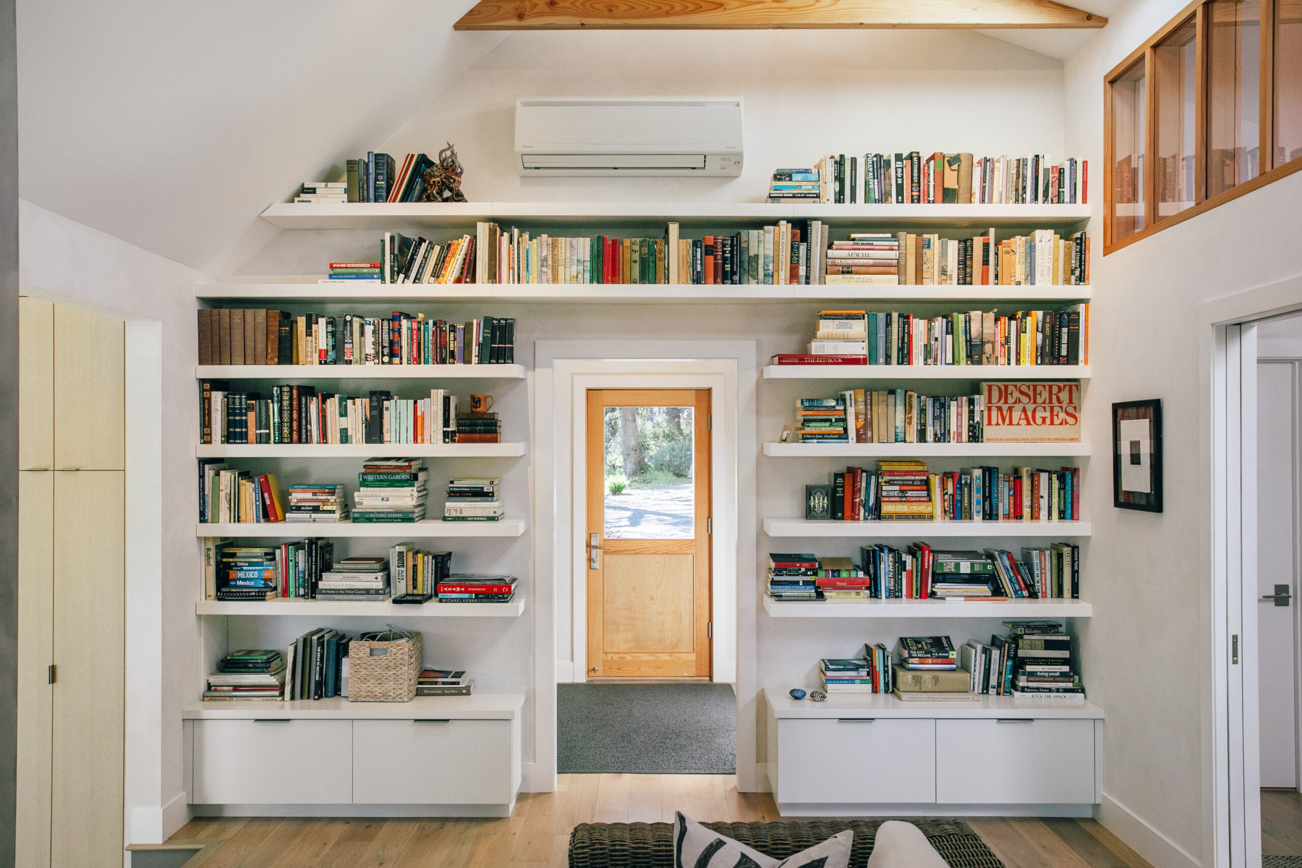 A floor-to-ceiling bookcase is a portal to the laundry and mudroom. (Eileen Roche)