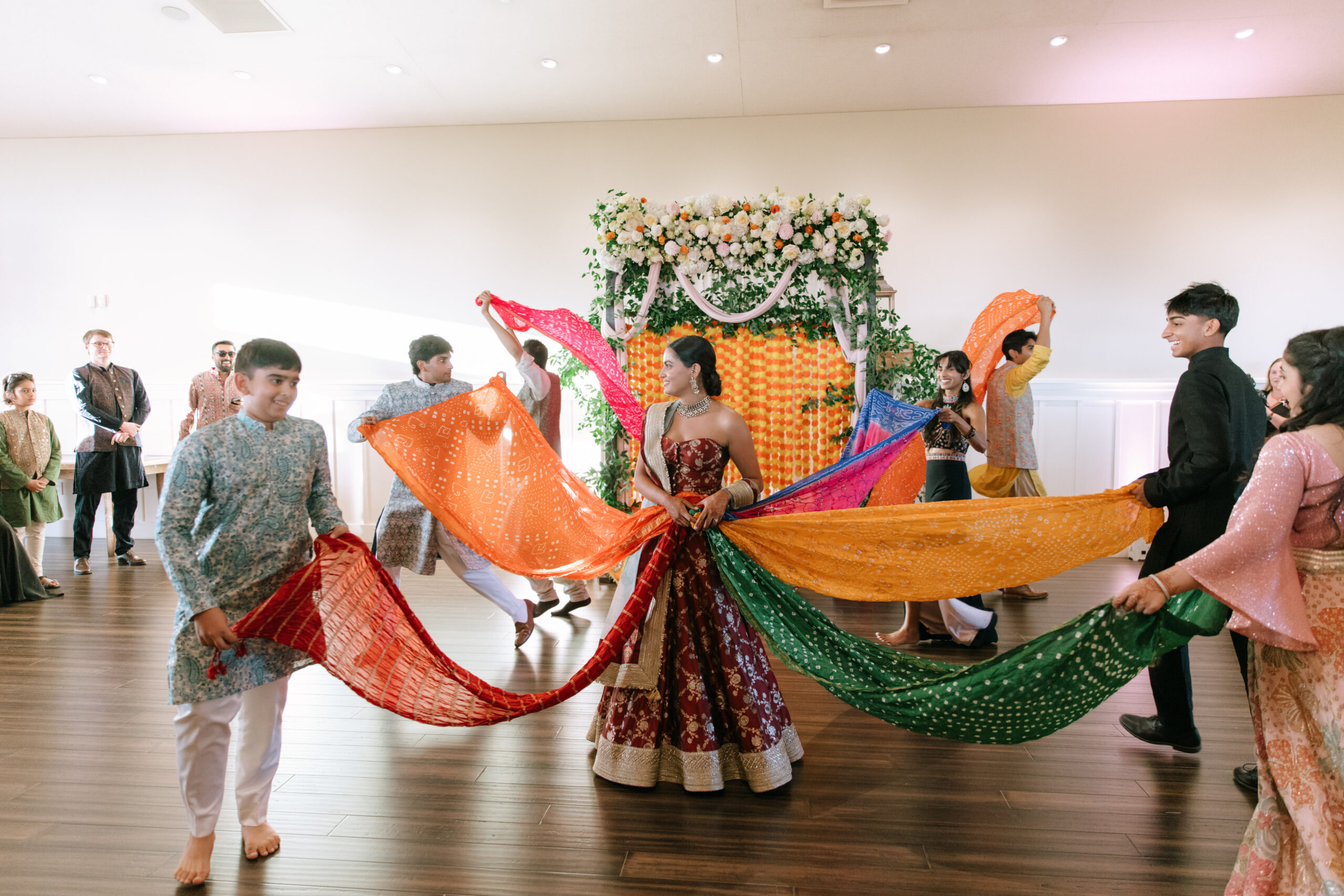Family and friends dance around Sanjana at a sangeet held at Paradise Ridge Winery two days before her wedding to Evan. (Katie Miller)