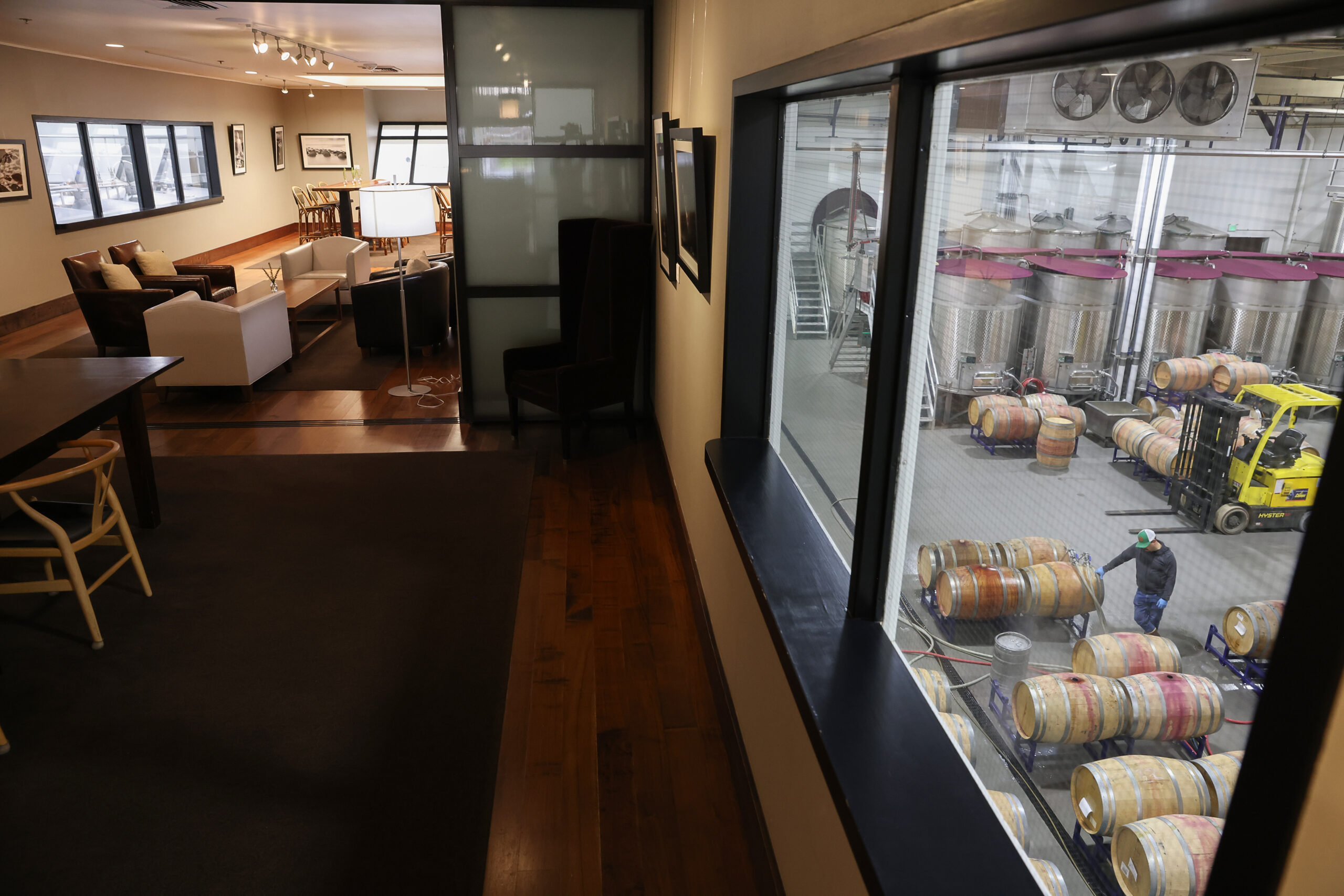 A large window affords guests a view of the cellar action from a tasting room at St. Supéry Estate Vineyards & Winery in Rutherford on Friday, January 30, 2026. (Christopher Chung/The Press Democrat)