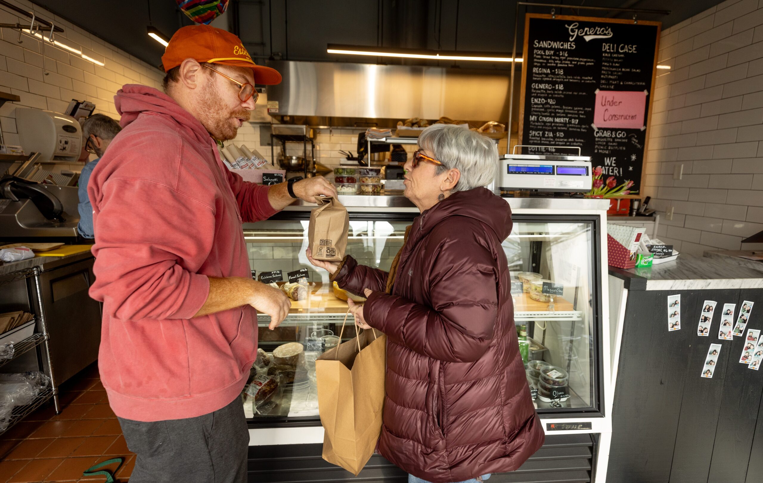 Chef/owner Ian Mark delivers an order to Kim Rothstein at Genero’s Deli Friday, Jan. 30, 2026 in Sebastopol’s Barlow district. (John Burgess/The Press Democrat)