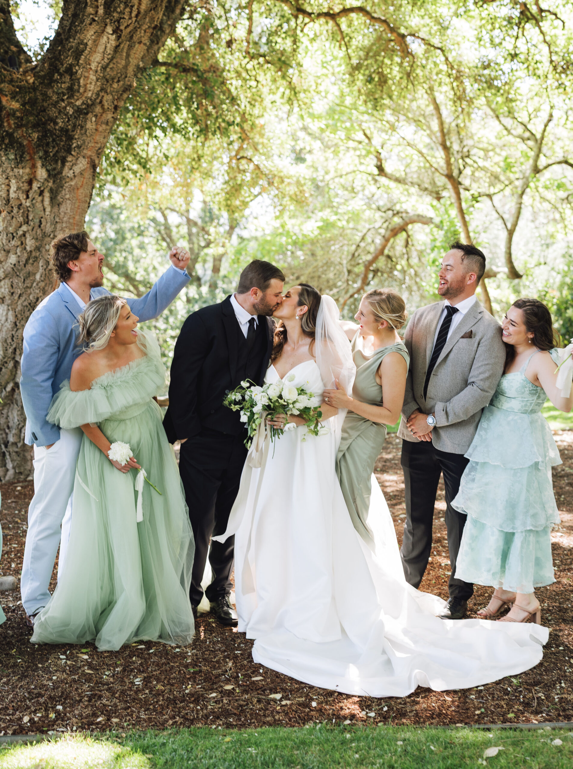 The couple exchanged vows and kissed to guests’ applause beneath the cool shade of the majestic oak tree. (Ashley Carlascio)
