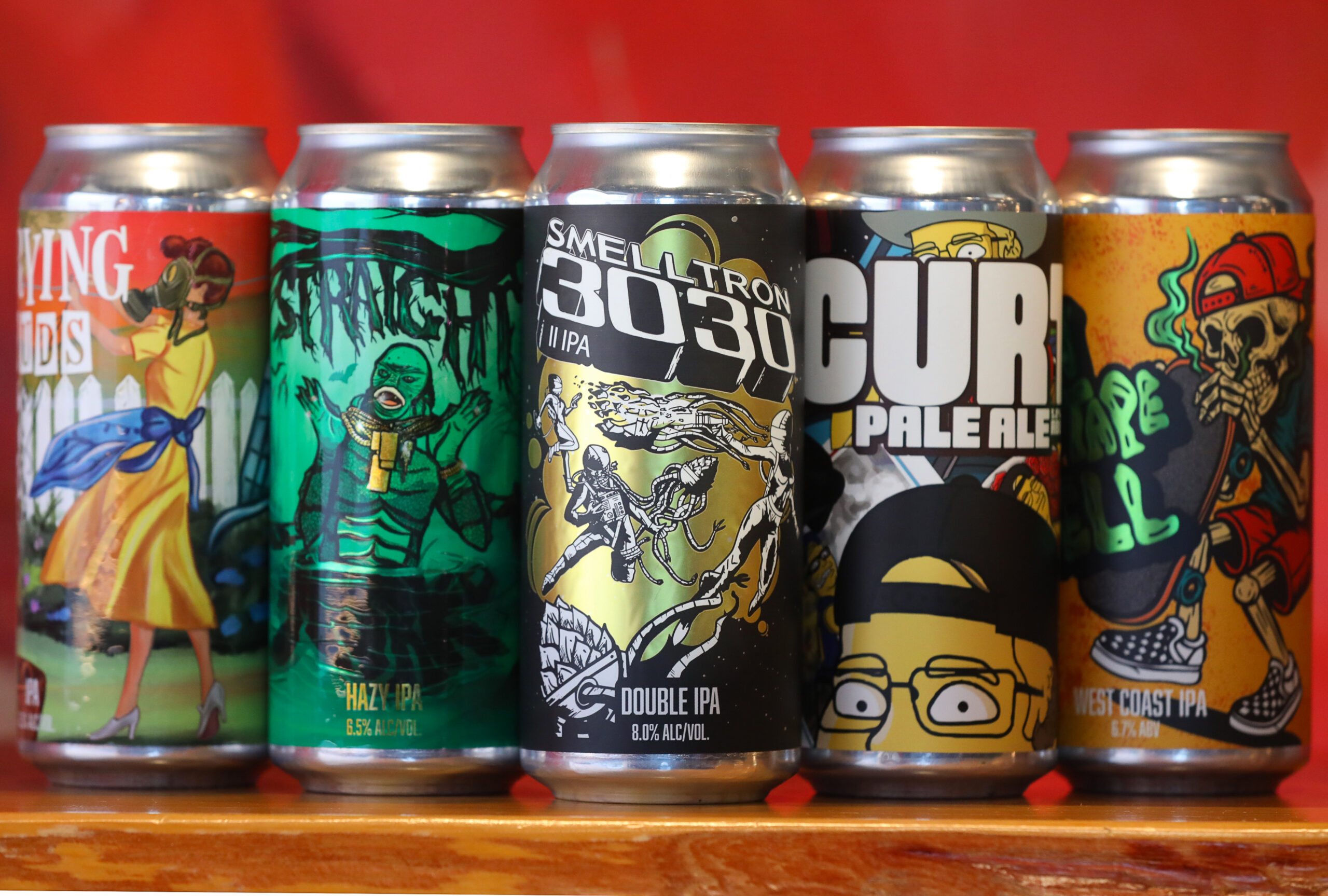 Some of the beer cans featuring the artwork of Cooperage Brewing Company art director and head of design Nicky London in Santa Rosa on Tuesday, February 3, 2026. (Christopher Chung/The Press Democrat)