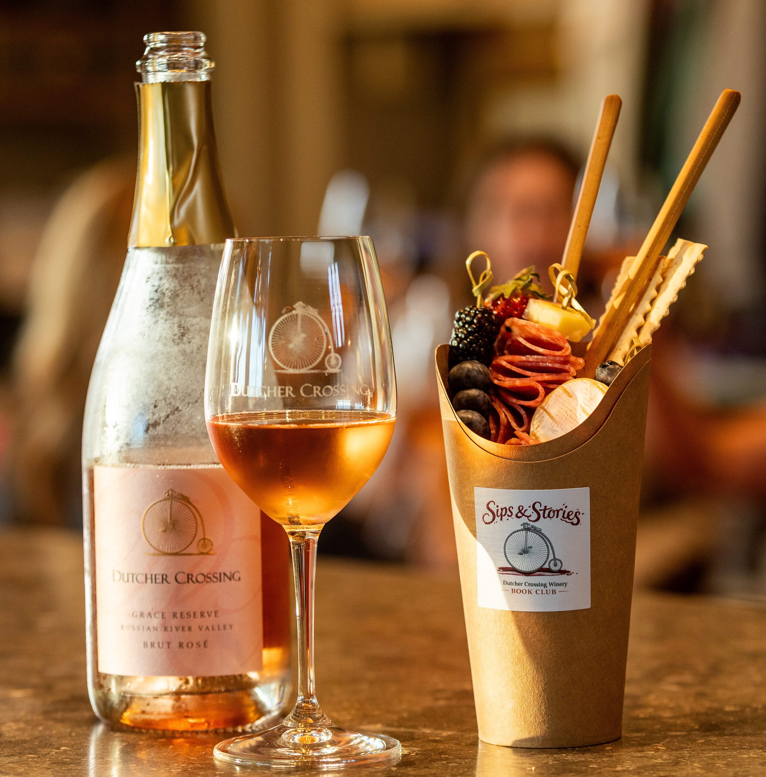 Before sitting down to discuss “The Widow Clicquot,” the Dutcher Crossing Winery Book Club paired the tale of the Grande Dame of Champagne with their Grace Reserve Brut Rose and a charcuterie cup Thursday Feb. 26, 2026 in the Dry Creek Valley. (John Burgess/The Press Democrat)