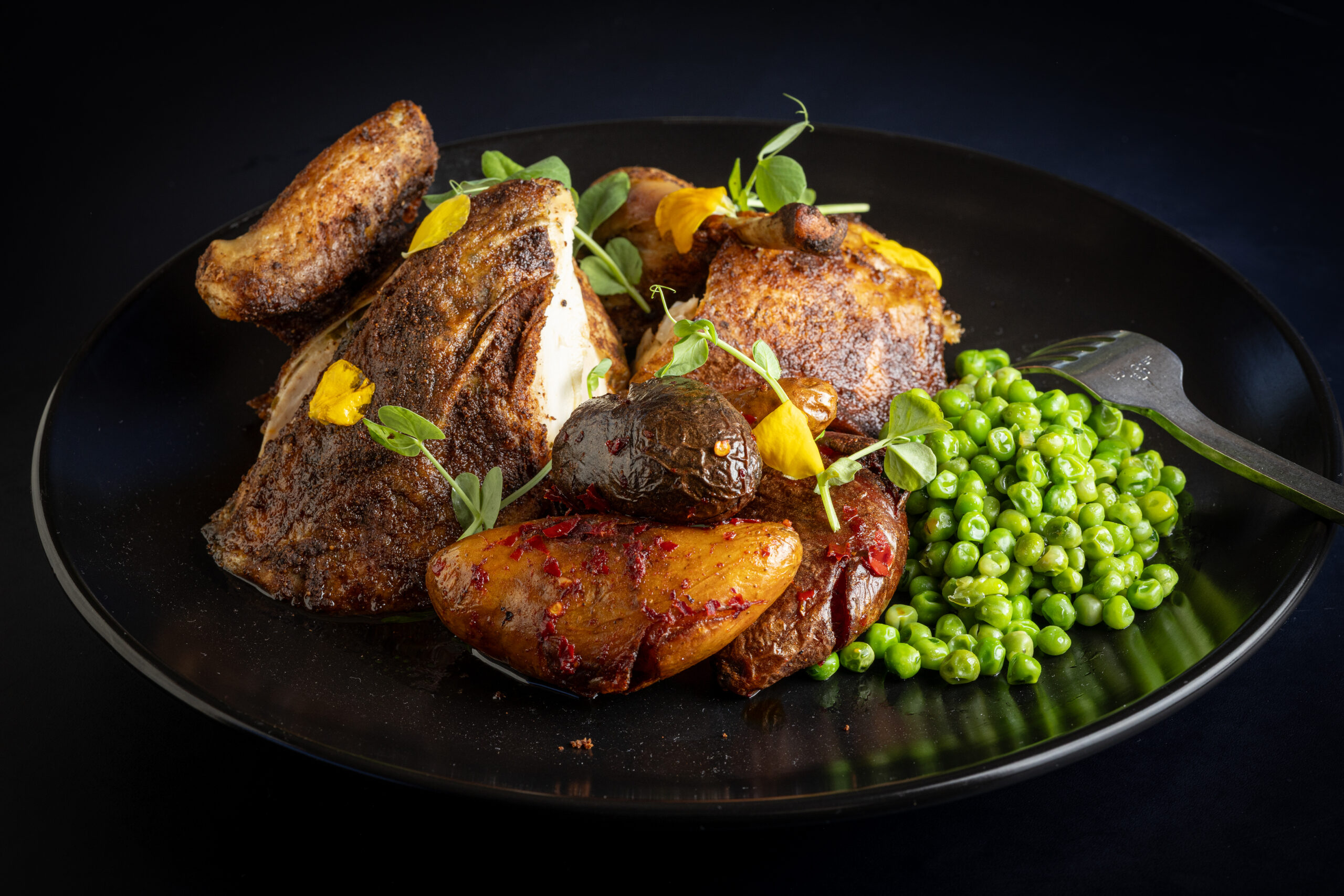 Poulet Roti, a classic roast chicken with harissa potatoes and petit pois, from Juju’s, a French-Moroccan dinner pop-up in the Acorn Café space on the square in Healdsburg. Photo taken Thursday, March 19, 2026. (John Burgess/The Press Democrat)