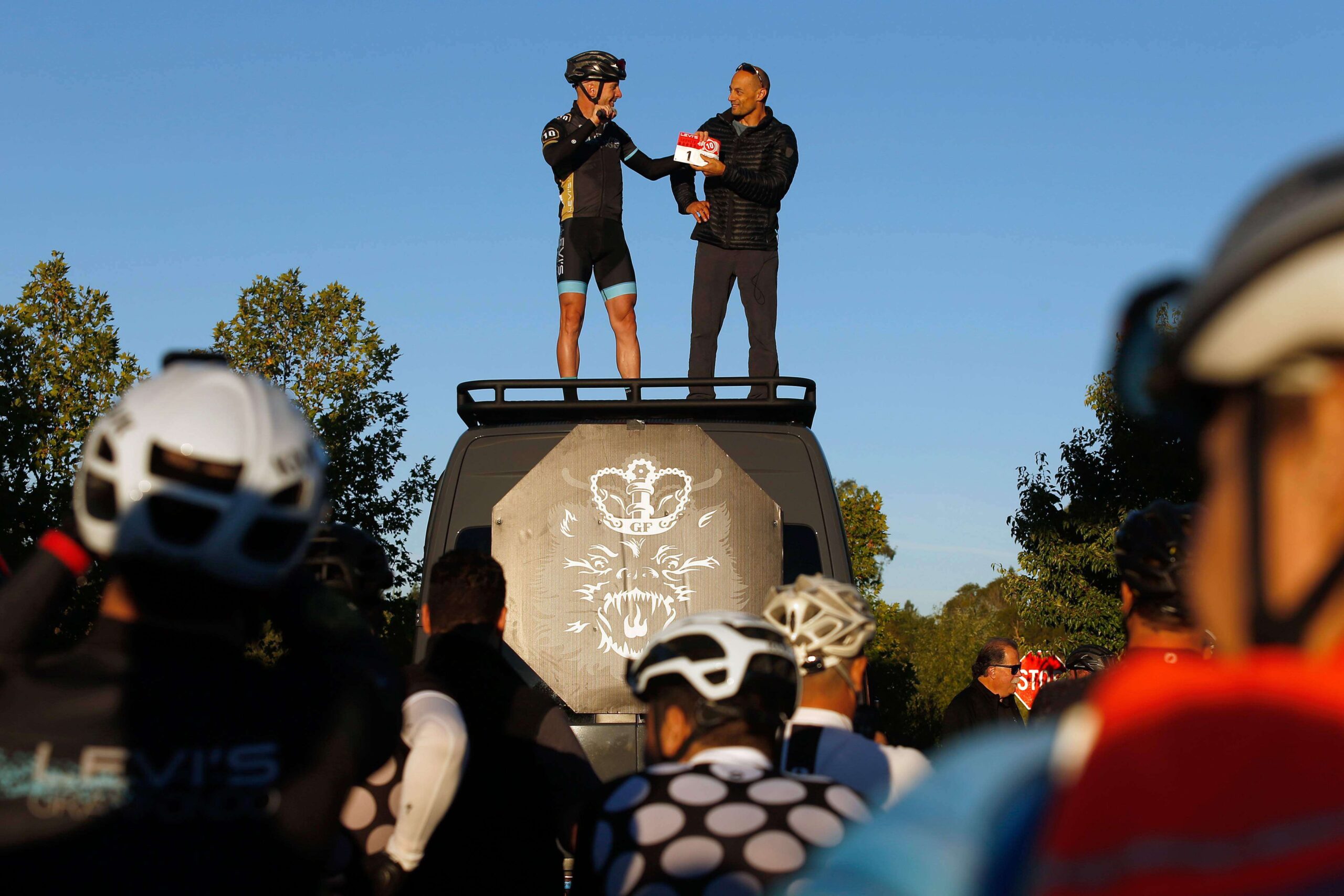 Levi Leipheimer, left, presents Bike Monkey founder Carlos Perez with the ceremonial bib No. 1 at the start of the 10th Levi's GranFondo at A Place to Play in Santa Rosa on Saturday, Oct. 6, 2018. (Alvin Jornada / The Press Democrat)