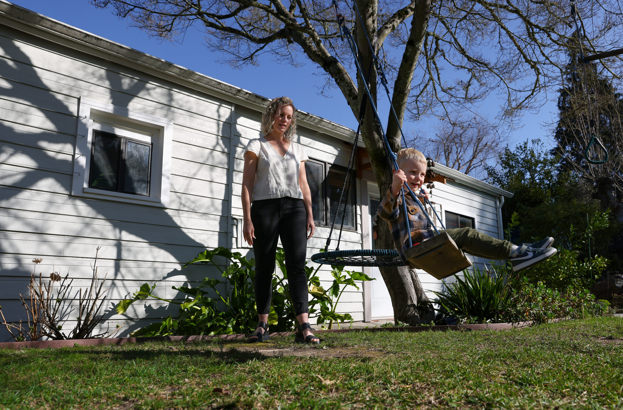 Corrin Messing pushes 2-year-old Leo on a backyard swing in Healdsburg on Friday, February 6, 2026. (Christopher Chung/The Press Democrat)