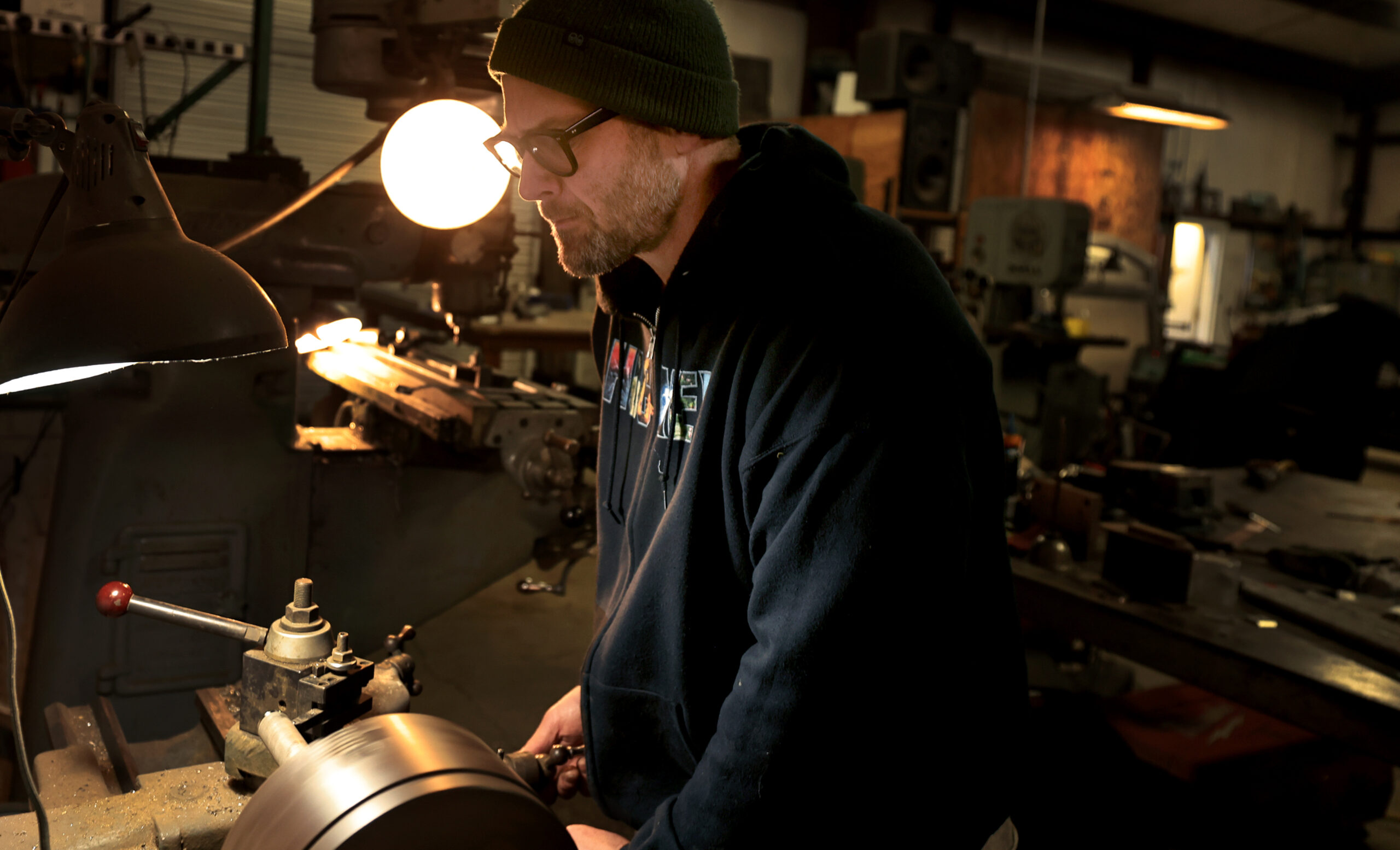 Klaus Rappensperger uses a metal lathe on piping to be used on custom metal project at Schnitzkraft Steel Artistry in Santa Rosa, Tuesday, Feb. 10, 2026. (Kent Porter / The Press Democrat)