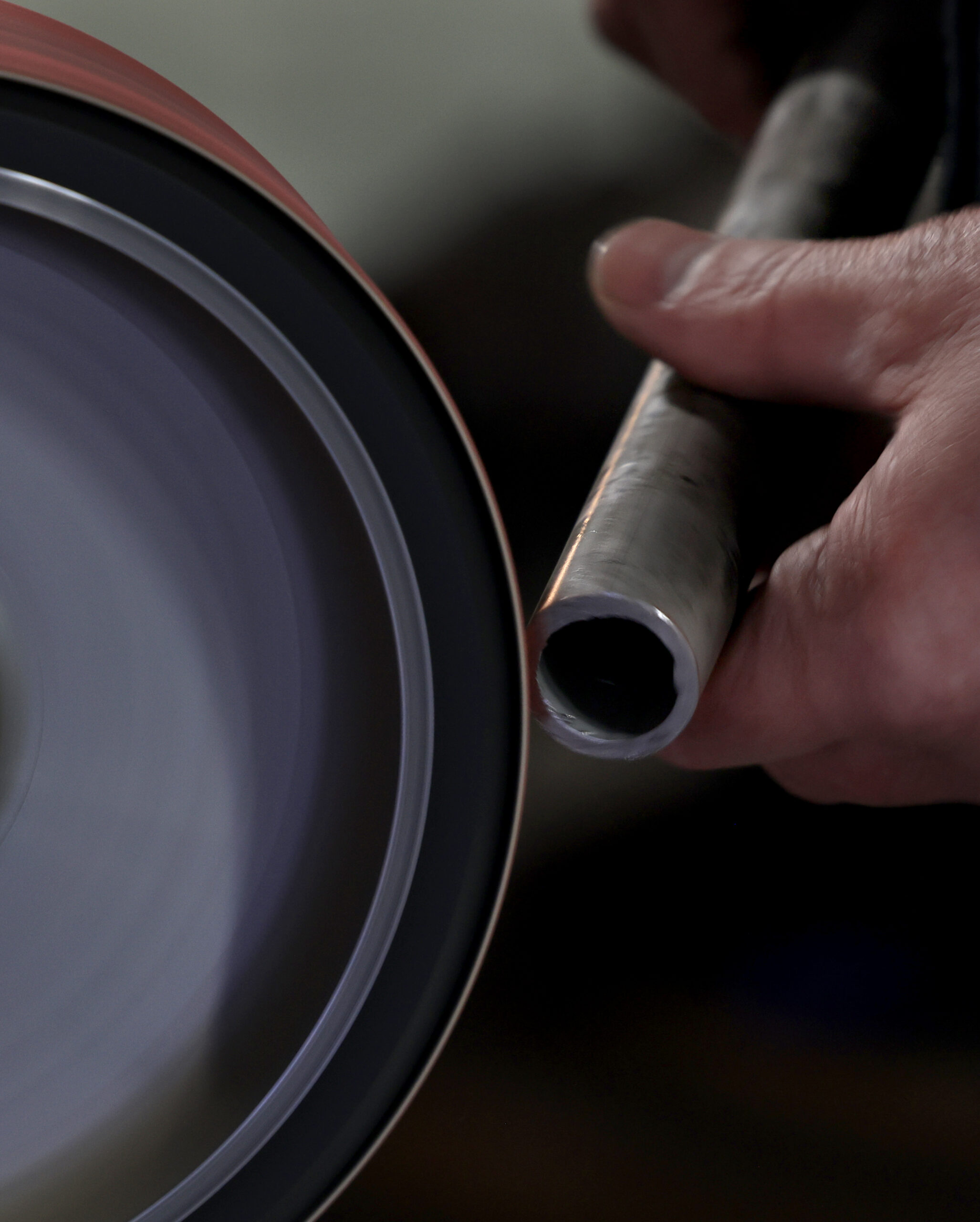 Klaus Rappensperger smooths the edges of a pipe, which will be used in a custom cabinet job at Schnitzkraft Steel Artistry in Santa Rosa, Tuesday, Feb. 10, 2026. (Kent Porter / The Press Democrat)