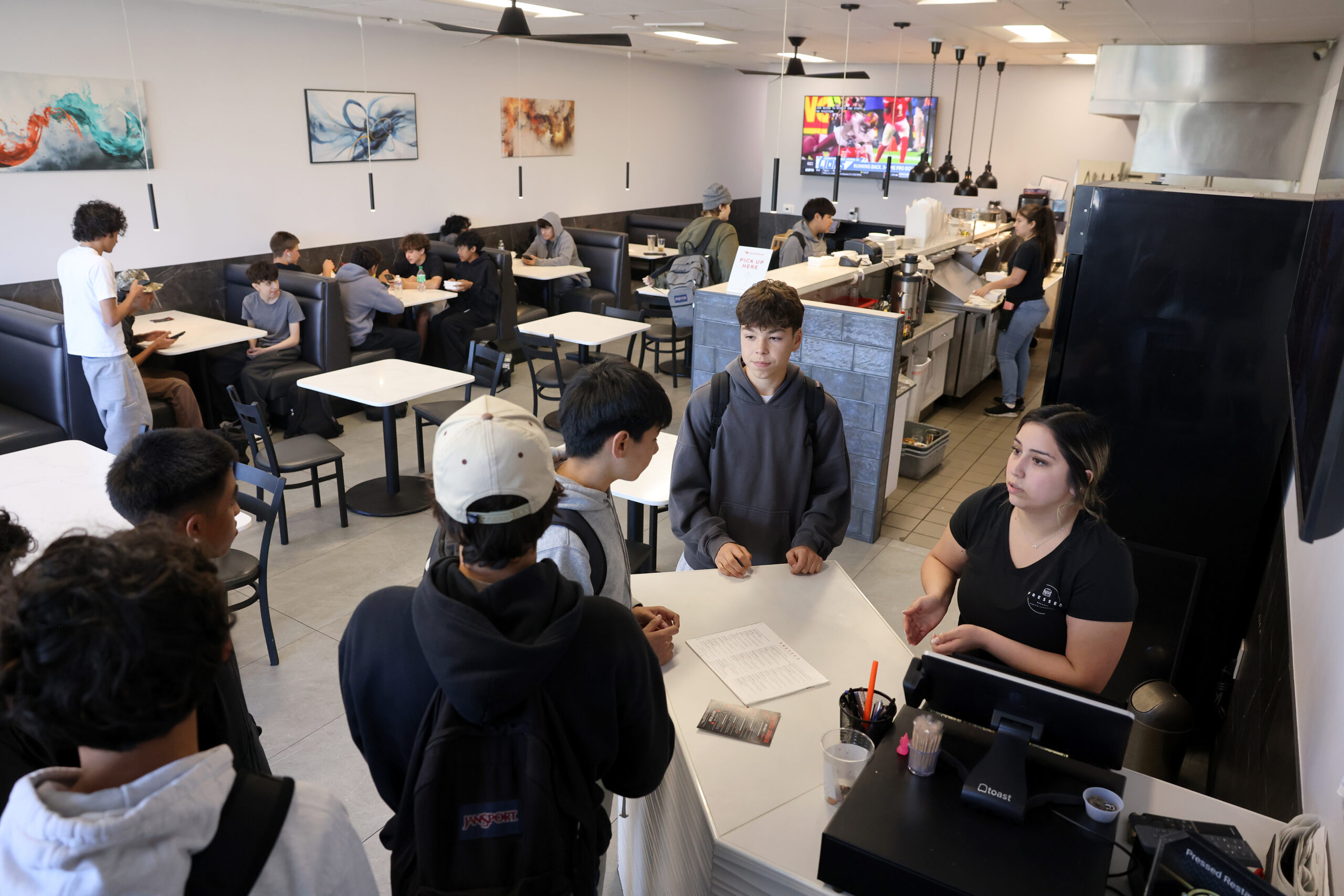 Rancho Cotate High School students wait in line for food on their lunch break at Pressed in Rohnert Park Friday, April 17, 2026. (Beth Schlanker / The Press Democrat)
