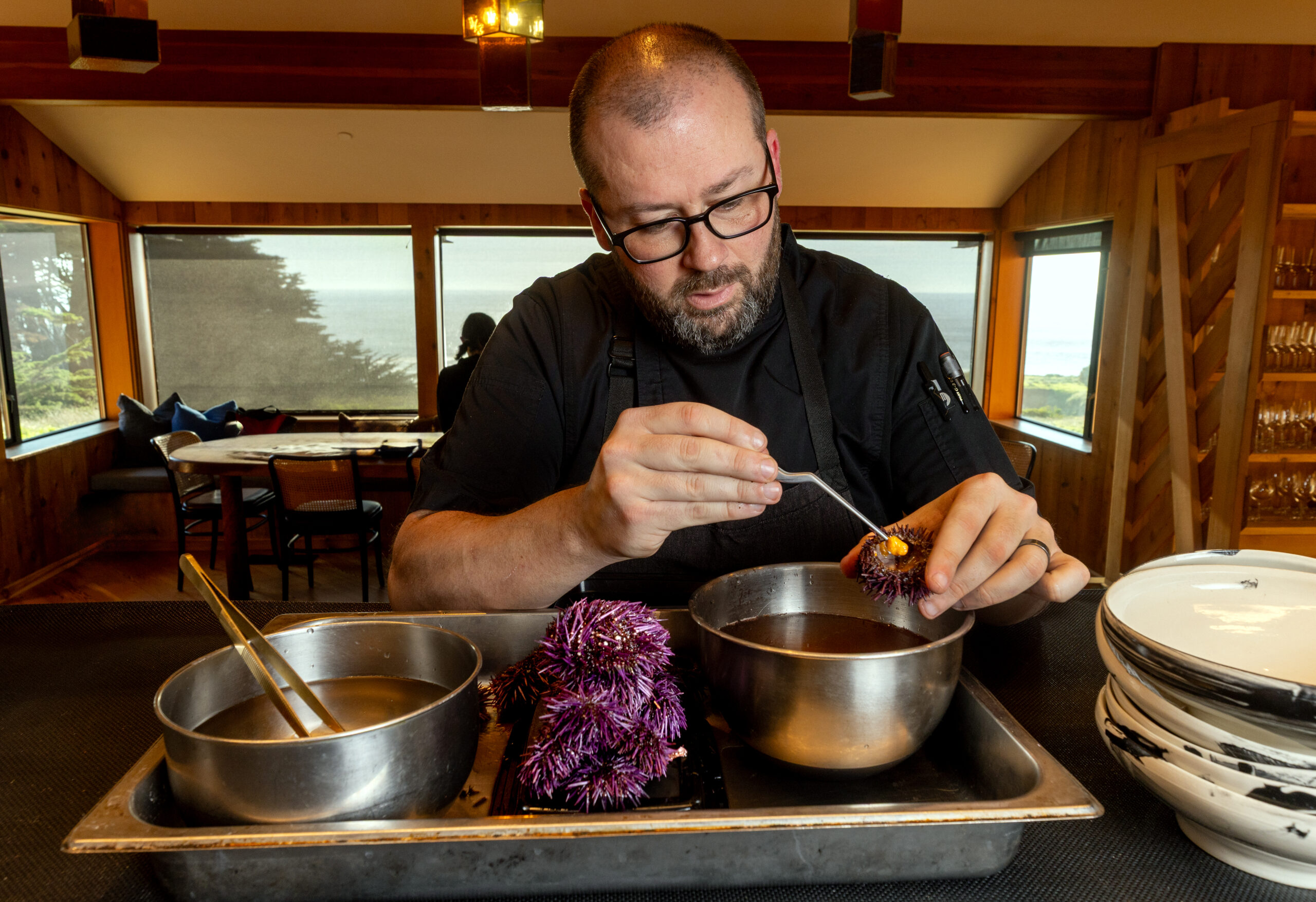 Sea Ranch Lodge chef Ryan Seal prepares a dish using uni from local purple sea urchins