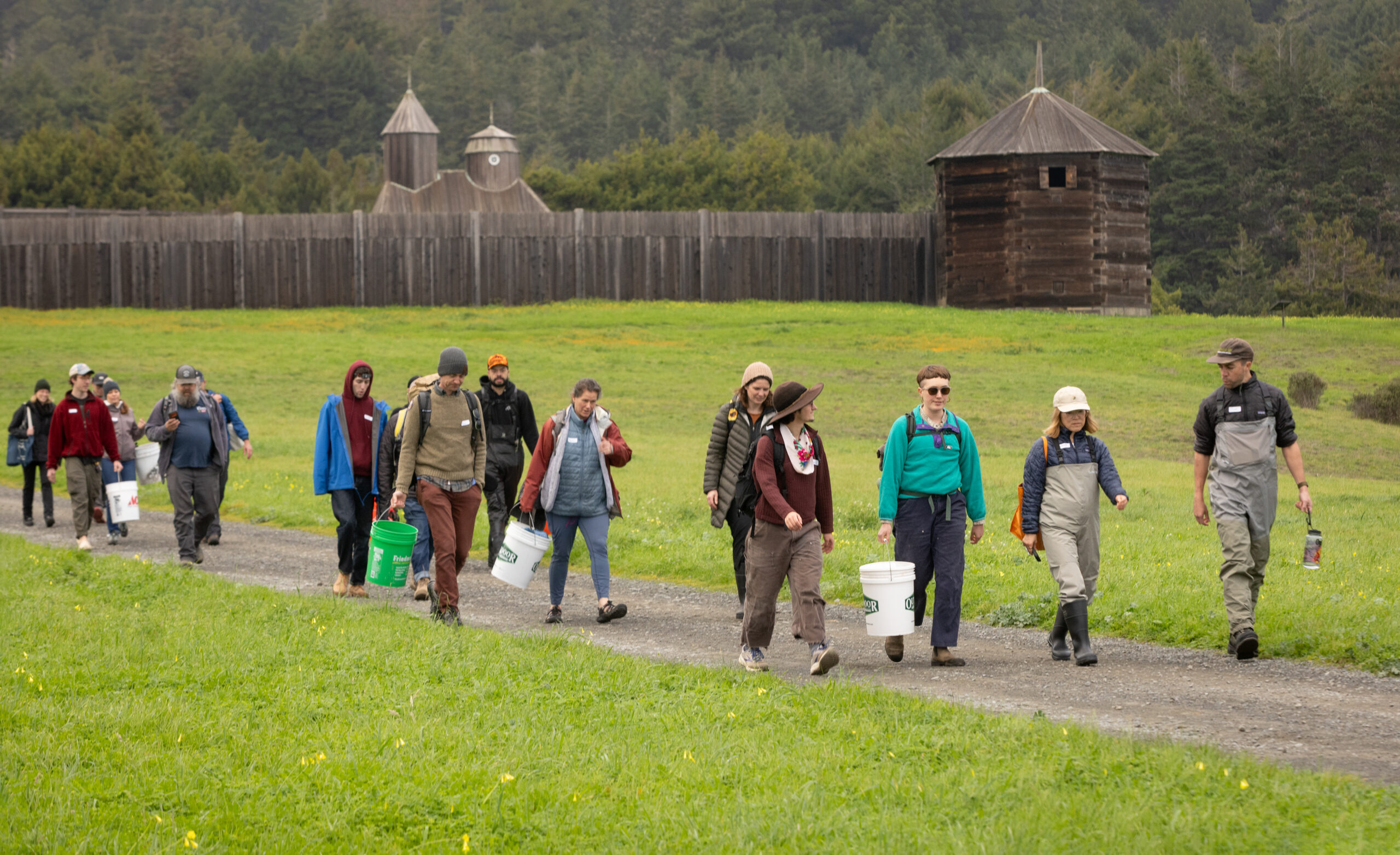 With their buckets and waders, participants in a sea urchin uni foraging class with Fork in the Path tours head past Fort Ross State Historic Park to Sand Beach Cove for the harvest Jan. 18, 2026 on the Sonoma Coast. (John Burgess / The Press Democrat)