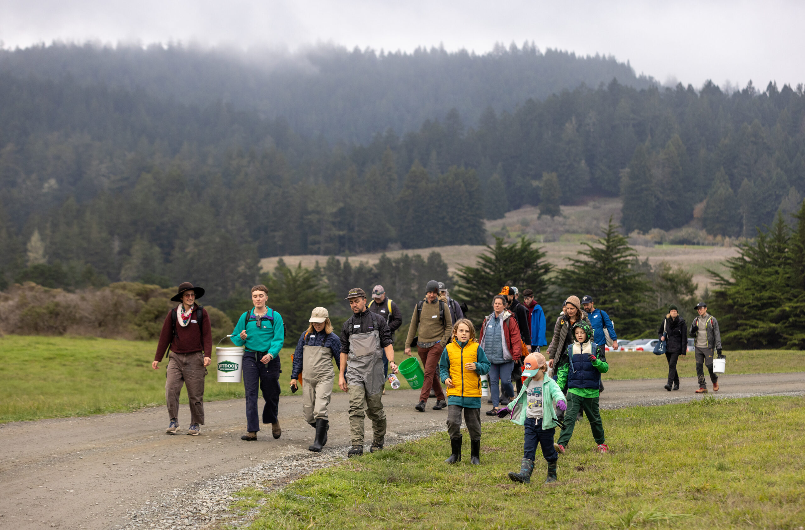 With their buckets and waders, participants in a sea urchin uni foraging class with Fork in the Path tours head past Fort Ross State Historic Park to Sand Beach Cove for the harvest Jan. 18, 2026 on the Sonoma Coast. (John Burgess / The Press Democrat)