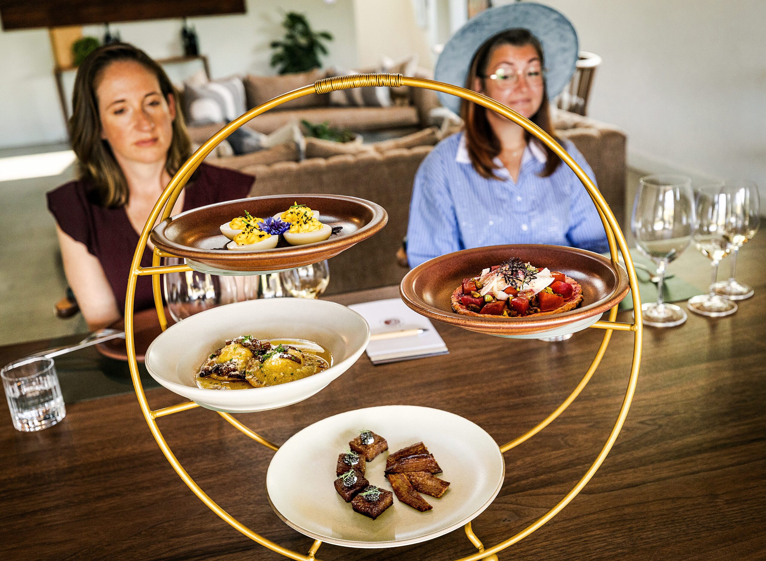 Carli Baxter, left, and Jacey Ohlinger taste Clif Family Winery & Farm wines paired with seasonal dishes crafted with ingredients harvested straight from their organic farm and local sources during the “Farm to Brunch Tasting Experience” Friday, April 24, 2026 in St. Helena. (John Burgess/The Press Democrat)