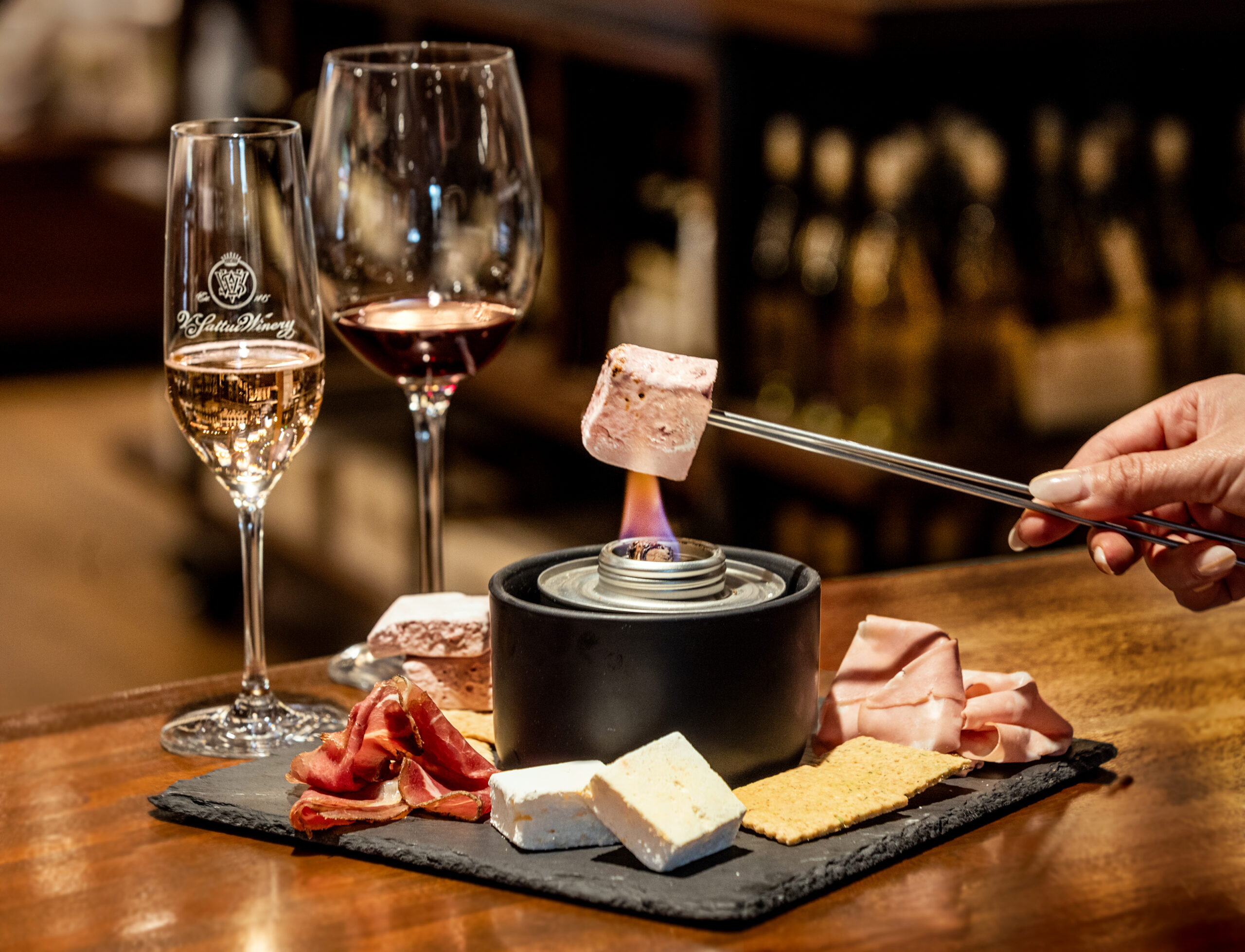 The V. Sattui Winery chef Katryana Zide reimagined s’mores as a savory course with infused marshmallows roasted tableside and layered with housemade crackers and cured meats paired with wines Thursday, April 23, 2026 from one of the oldest wineries in the Napa Valley. (John Burgess/The Press Democrat)