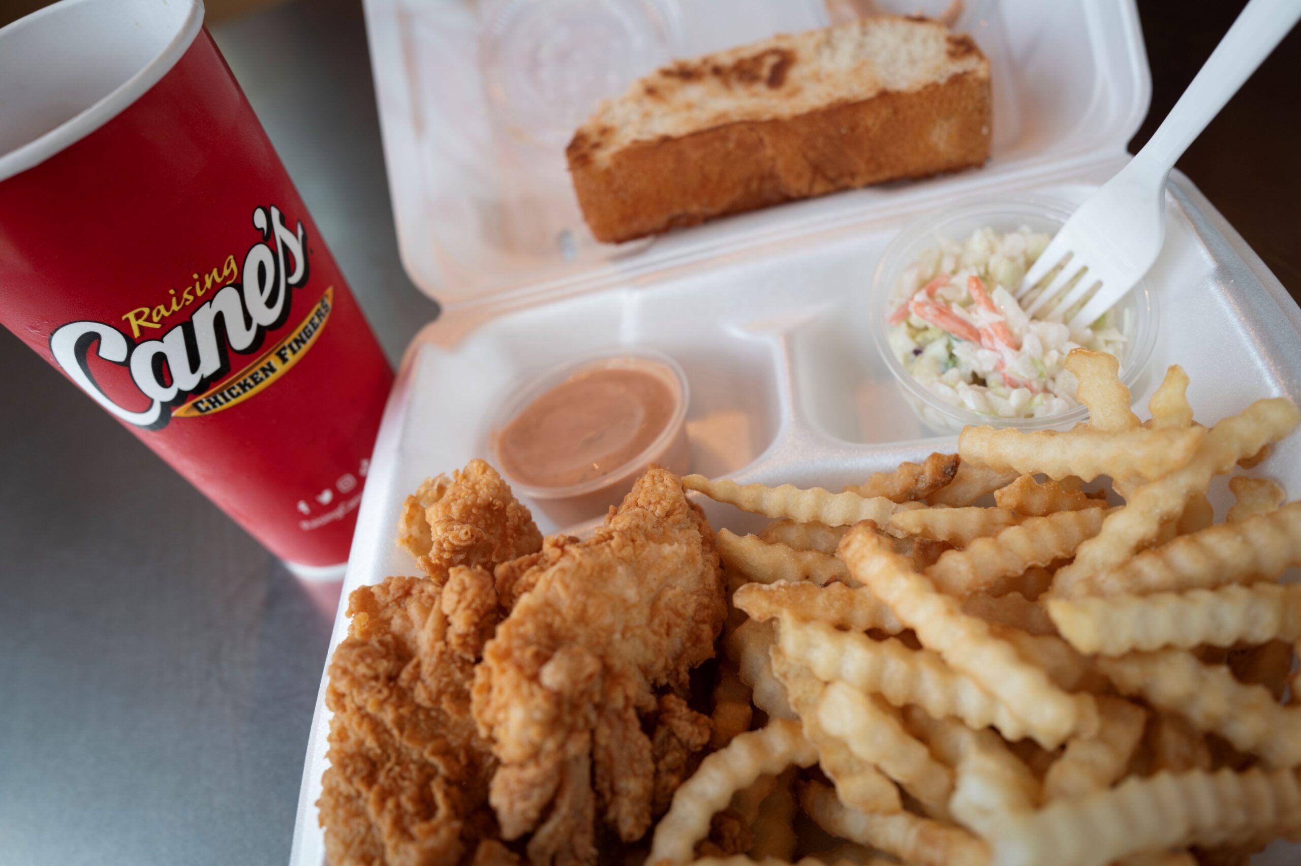 CHICAGO, ILLINOIS - JUNE 30: Chicken is served at a Raising Cane's restaurant on June 30, 2025 in Chicago, Illinois. Raising Cane’s overtook KFC to become the nation's third-largest chicken chain behind Chick-fil-A and Popeyes. (Photo Illustration by Scott Olson/Getty Images)