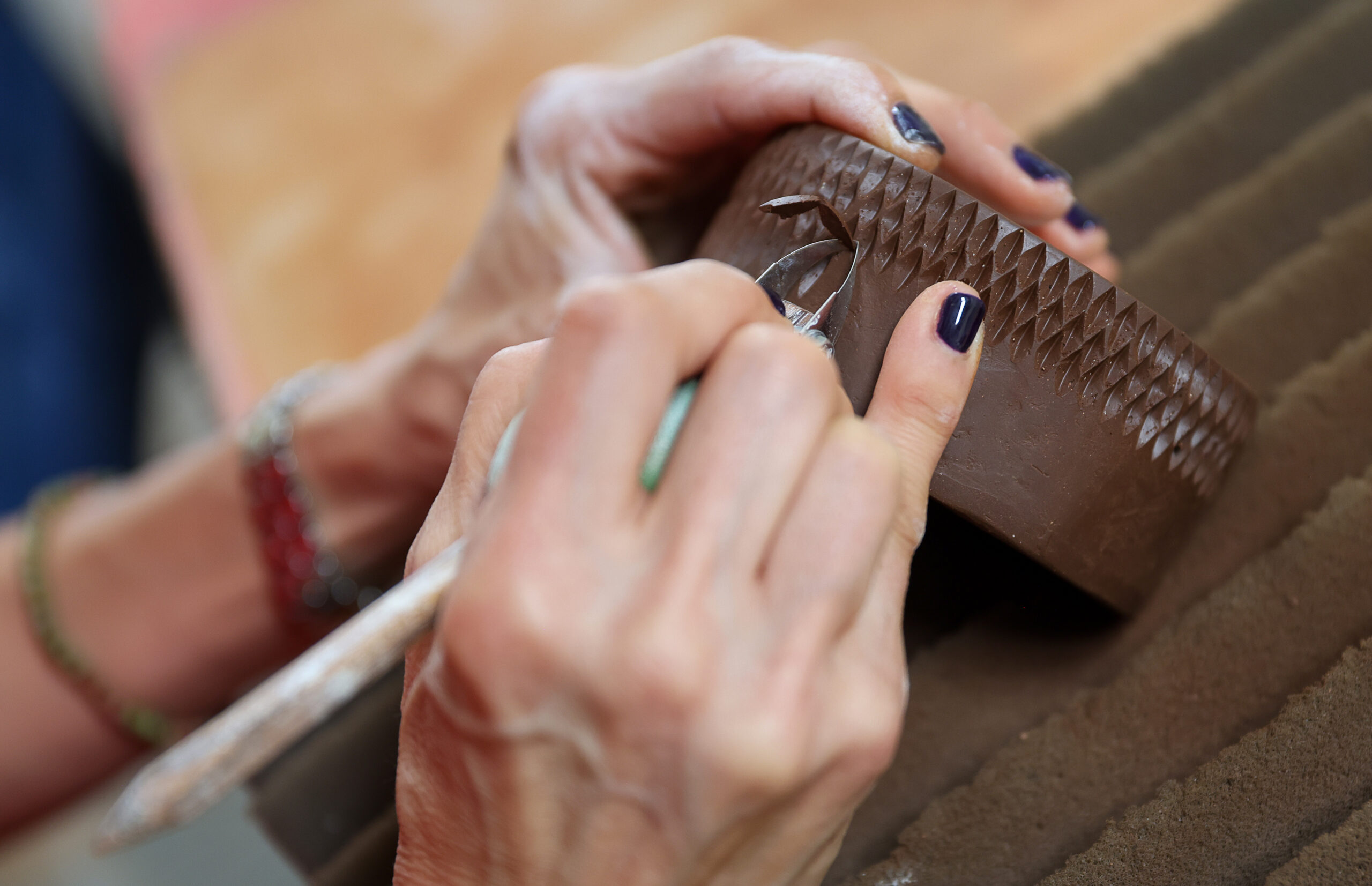 Jee Park, of Seoul Sister Studio, works on etching a clay bowl at her studio in Healdsburg on Thursday, March 19, 2026. (Christopher Chung/The Press Democrat)