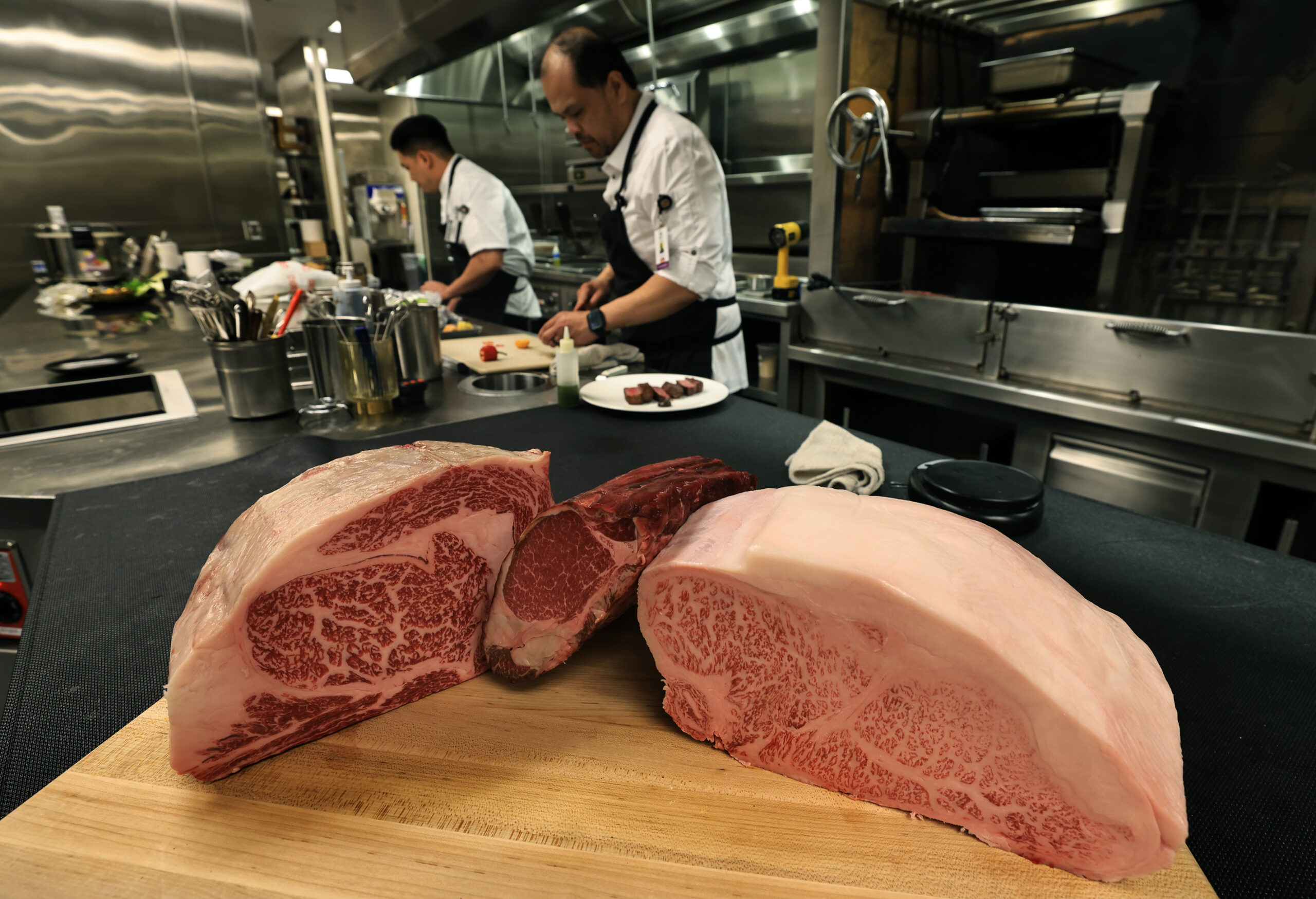 Chef Roy Allamar, middle, uses different grades of Wagyu beef at AYA, located inside Graton Resort and Casino, Wednesday, June 17, 2026. (Kent Porter / The Press Democrat)