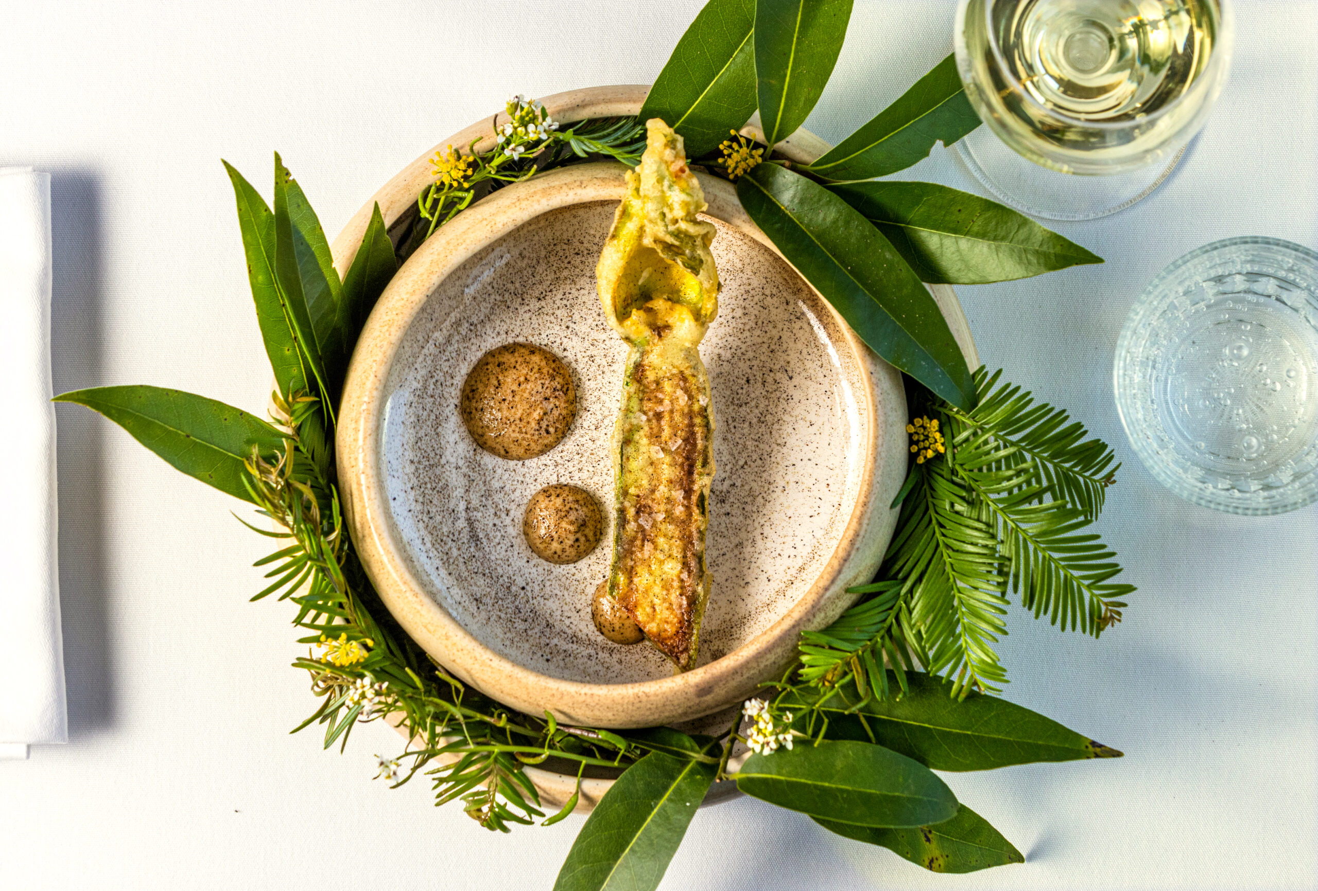 For the weekly chef’s amuse-bouche, Tempura Squash with the blossom attached with charred fennel aioli and dusted with a black trumpet powder from the Bohemian Bistro Friday, June 12, 2026 in Occidental. (John Burgess/The Press Democrat)