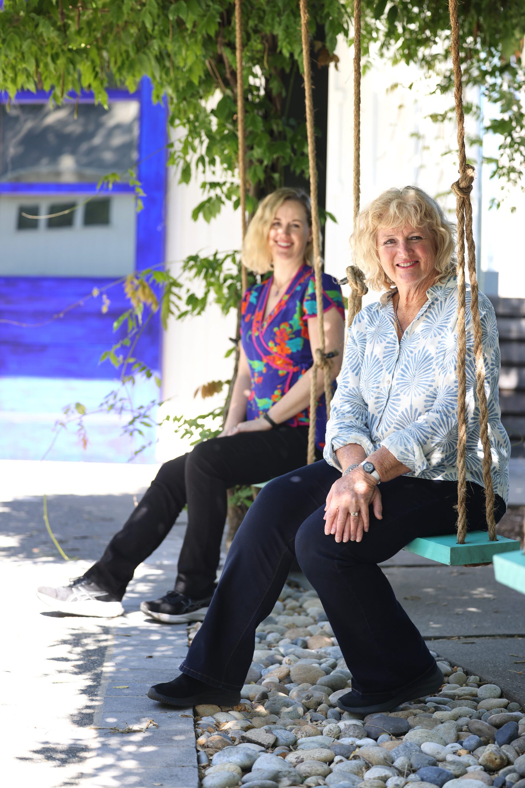 Heidi Peterson Barrett and her daughter Remi sit on swings outside La Sirena tasting room in Calistoga