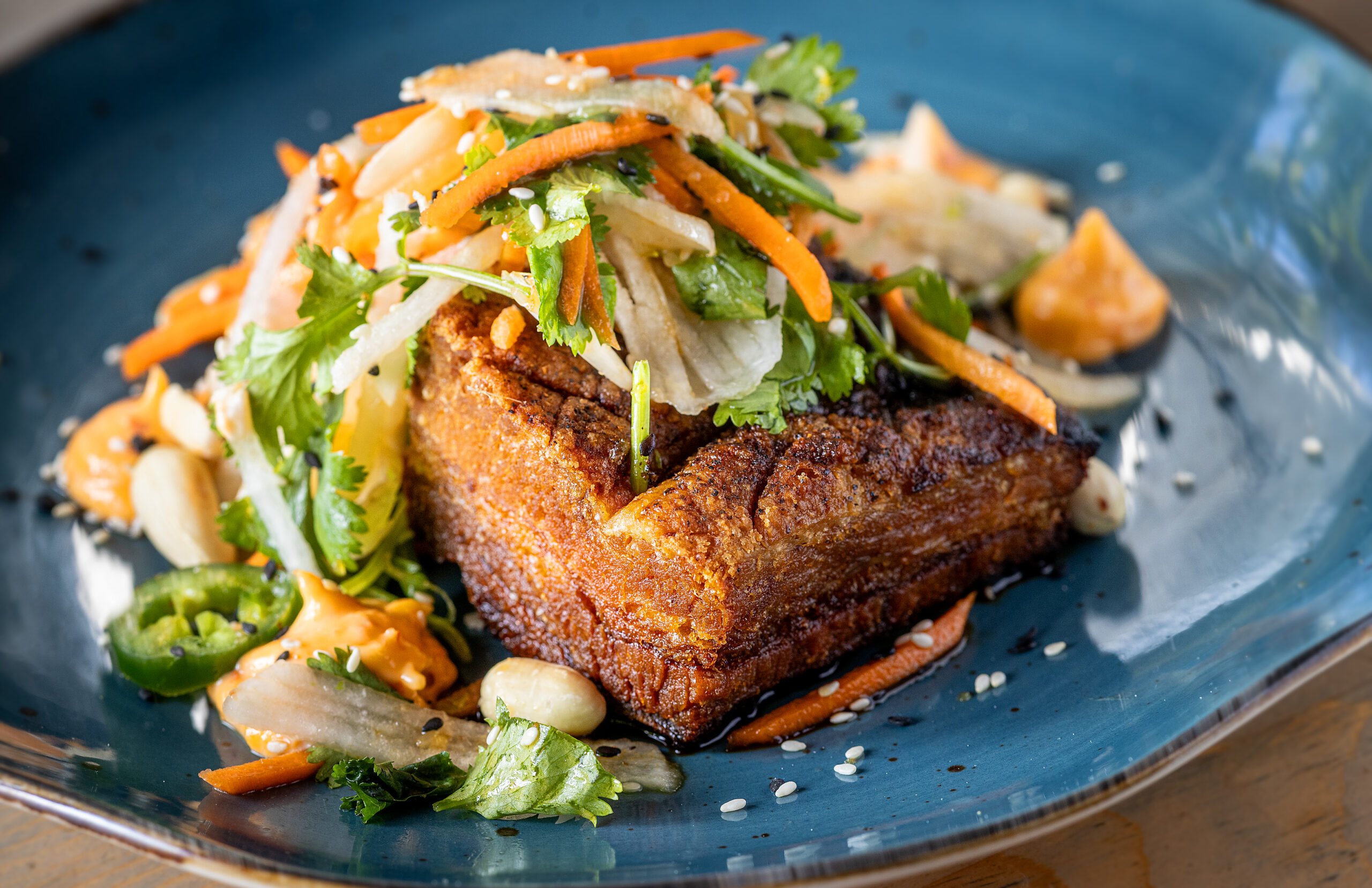 Pork Belly with bánh mi veggies, Vietnamese fish sauce glaze, sambal aioli and peanuts from Salt & Stone in the heart of the Sonoma Valley Monday, June 1, 2026 in Kenwood. (John Burgess/The Press Democrat)