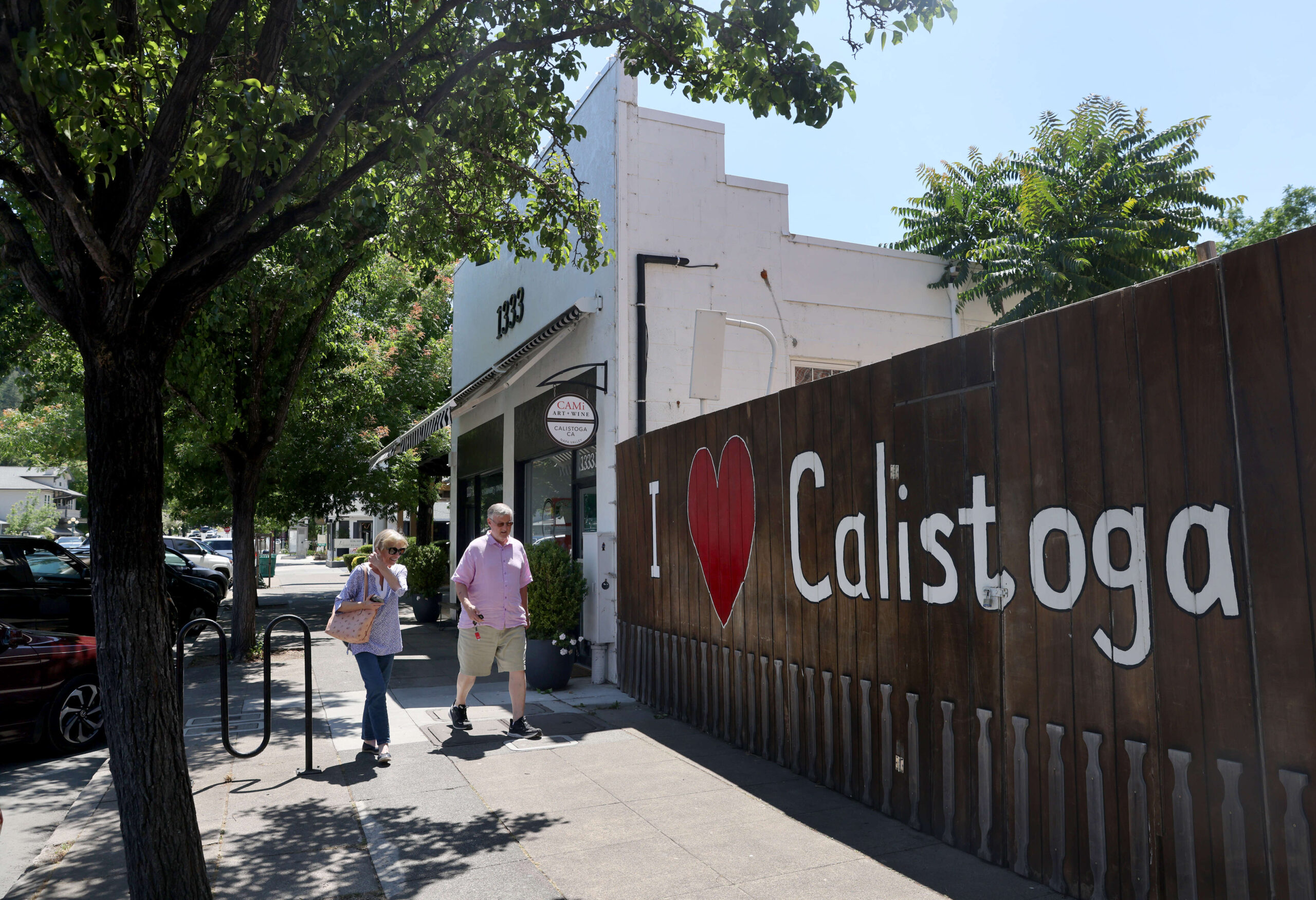 Pedestrians walk past an “I Love Calistoga” mural along Lincoln Avenue (Highway 29) in downtown Calistoga, Tuesday, June 20, 2023. (Beth Schlanker / The Press Democrat)