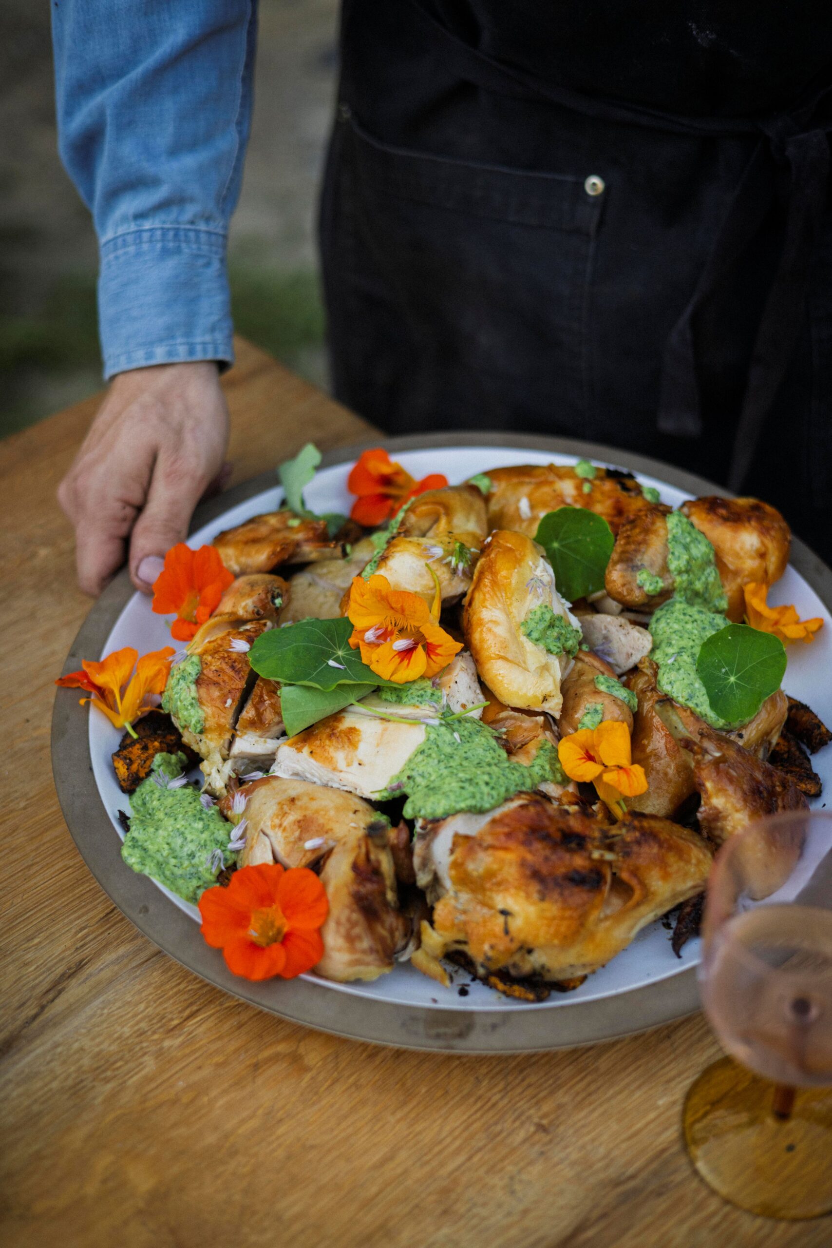 The signature dish at Lee Desrosiers' outdoor dinners is "Hell Chicken," cooked over an open fire