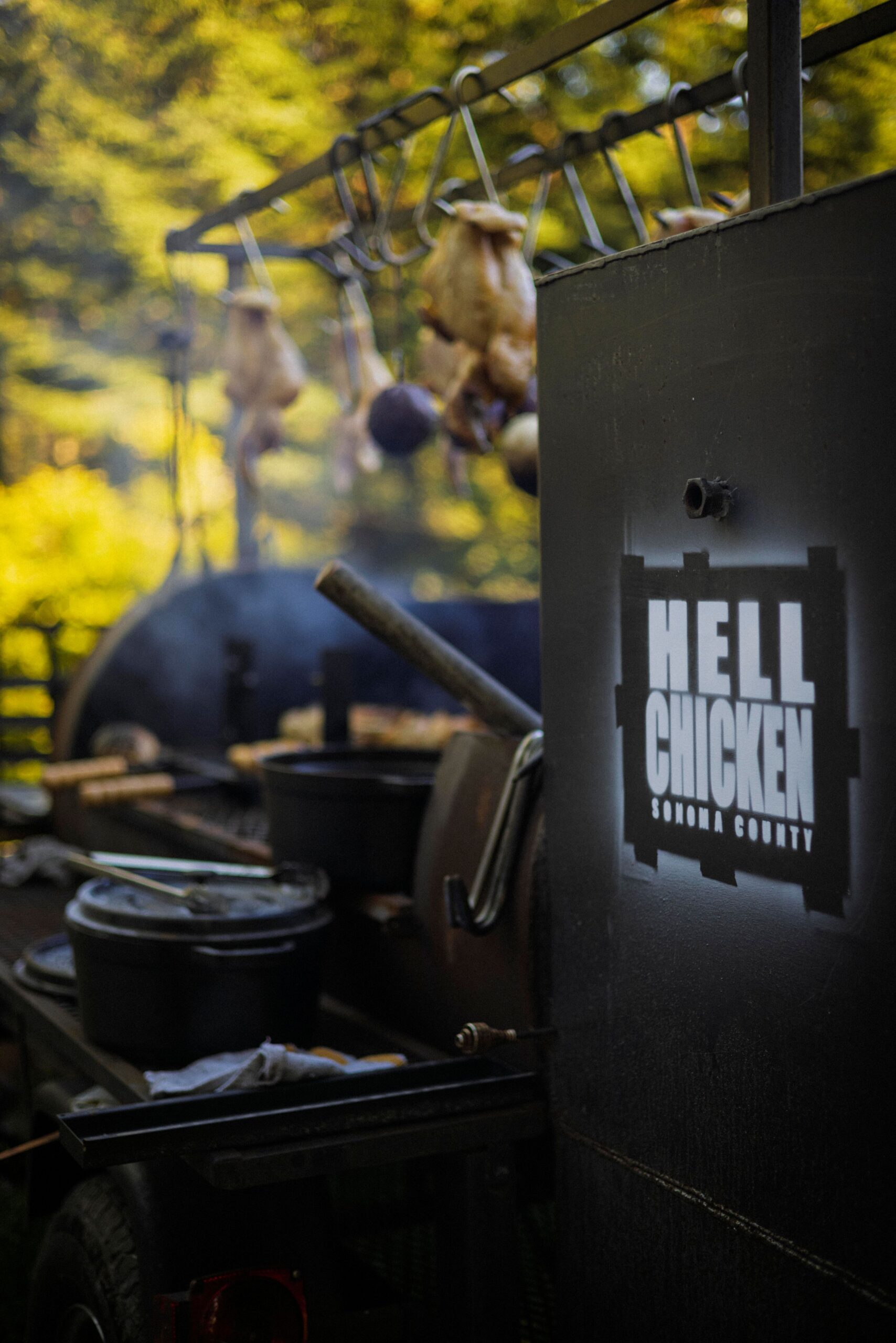 Chef Lee Desrosiers slow-roasts his signature "Hell Chicken" over coals in a converted pig smoker.