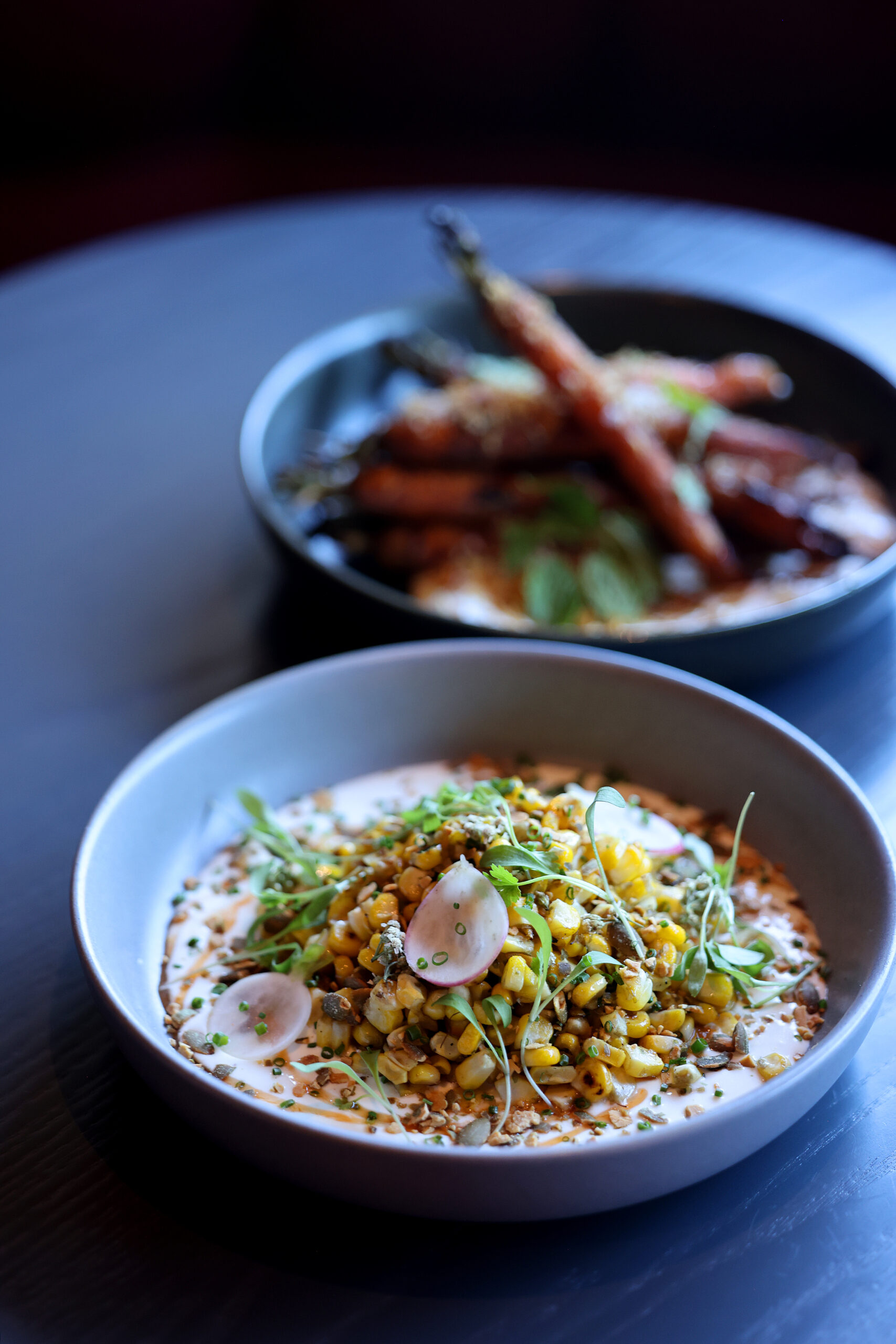 The sweet corn, front, and roasted carrots, rear, at Dead Letter restaurant in Sonoma Wednesday, July 15, 2026. (Beth Schlanker / The Press Democrat)