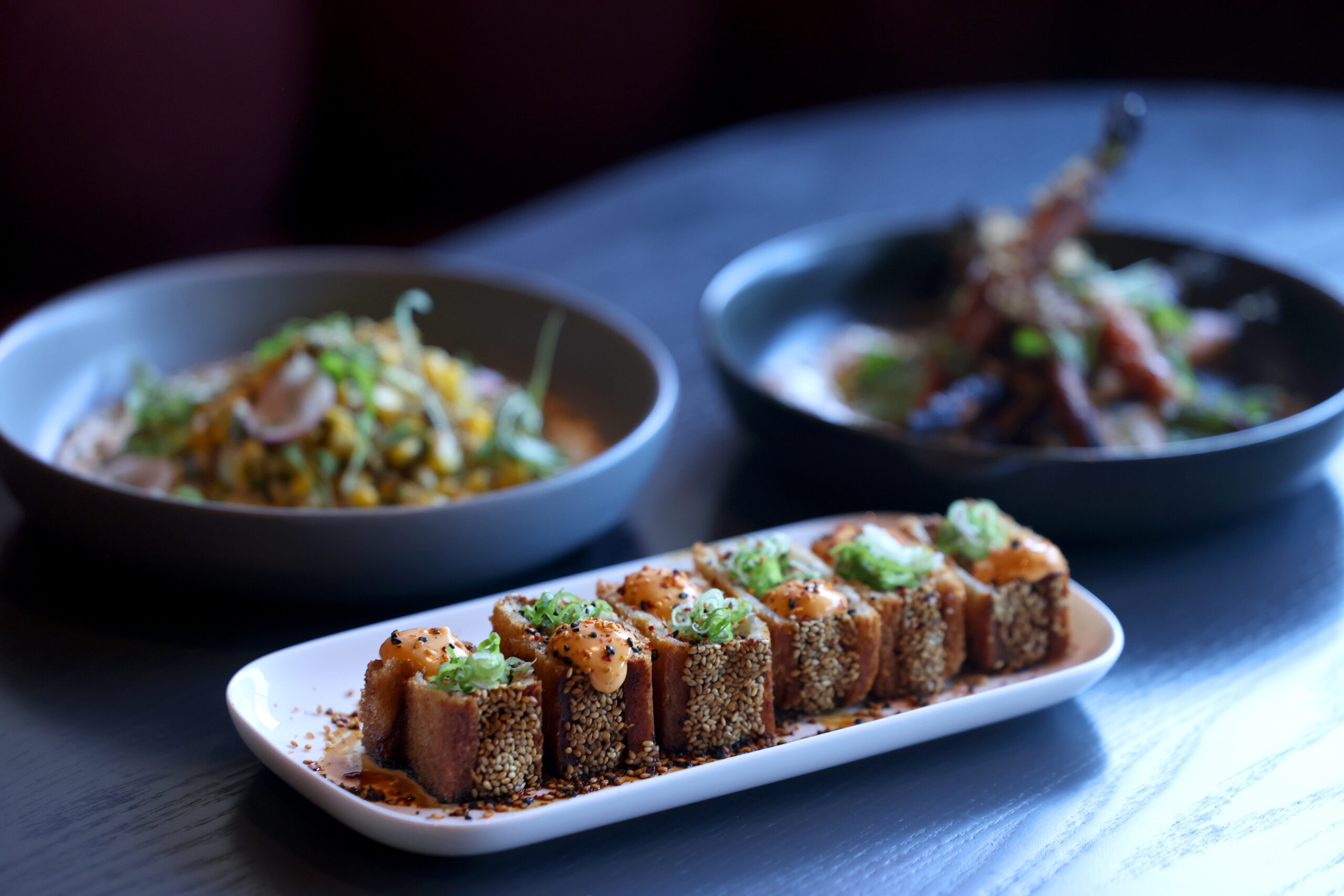 Shrimp toast accompanied by the sweet corn, left, and roasted carrots, right, at Dead Letter restaurant in Sonoma Wednesday, July 15, 2026. (Beth Schlanker / The Press Democrat)
