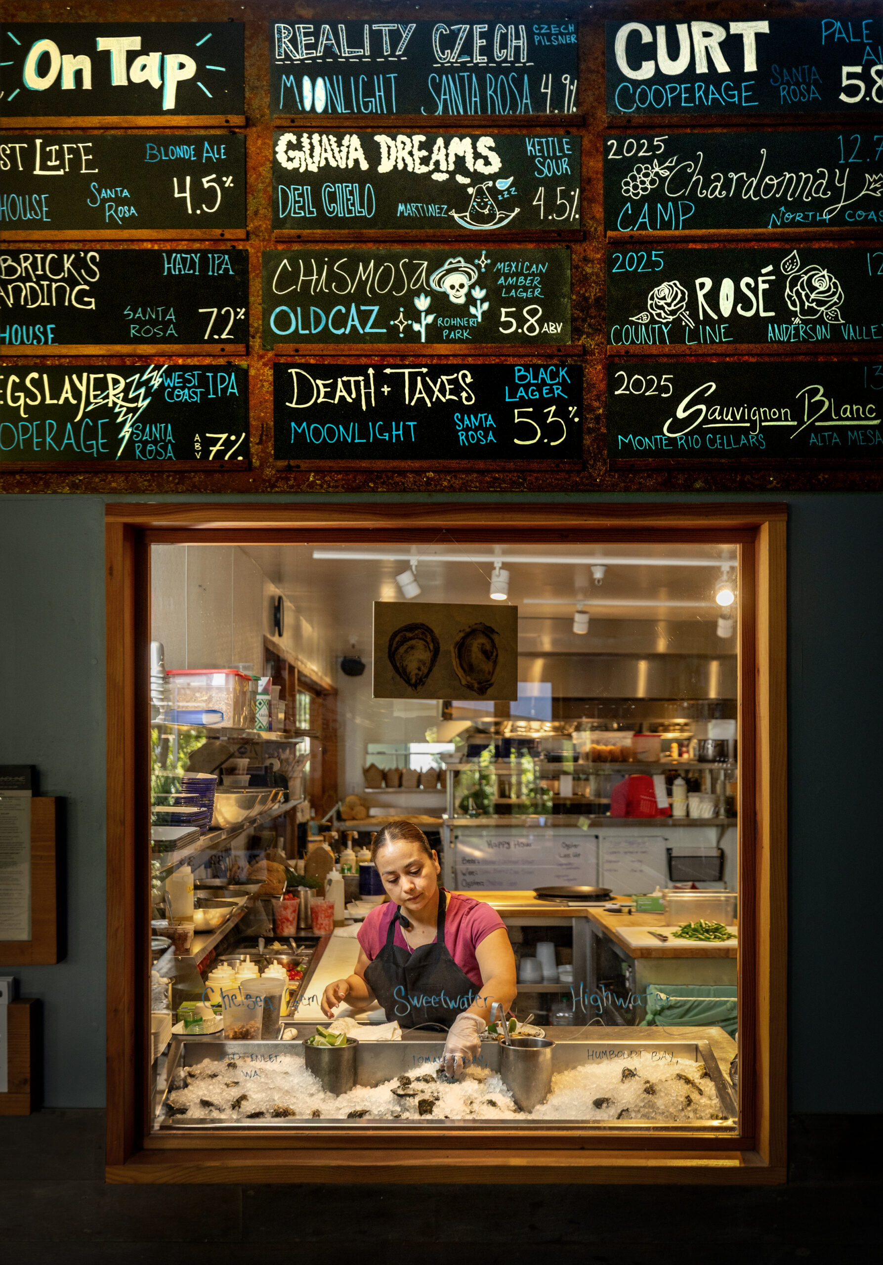 Grecia Garcia picks from three types of oysters for a fresh oyster plate at Handline Thursday, July 9, 2026 in Sebastopol. (John Burgess/The Press Democrat)