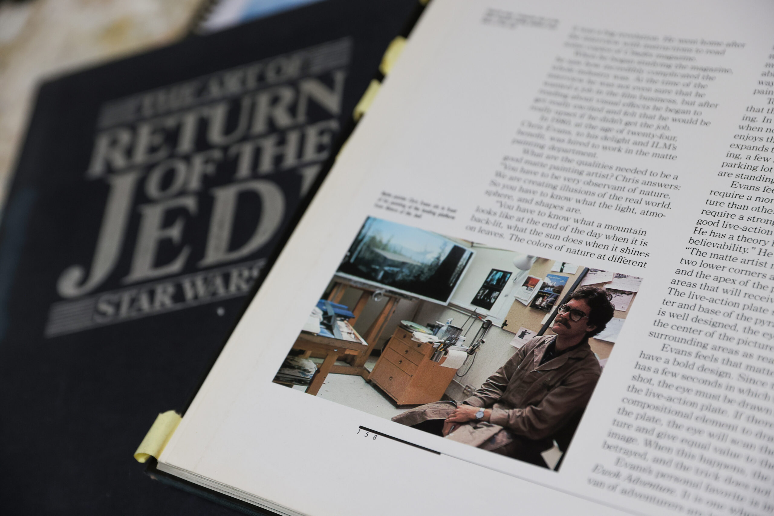 A photo of Christopher Leith Evans in a book about the making of Star Wars: Return of the Jedi”. Evans painted a variety of environments for the movie. Photo taken in Healdsburg on Monday, May 11, 2026. (Christopher Chung/The Press Democrat)