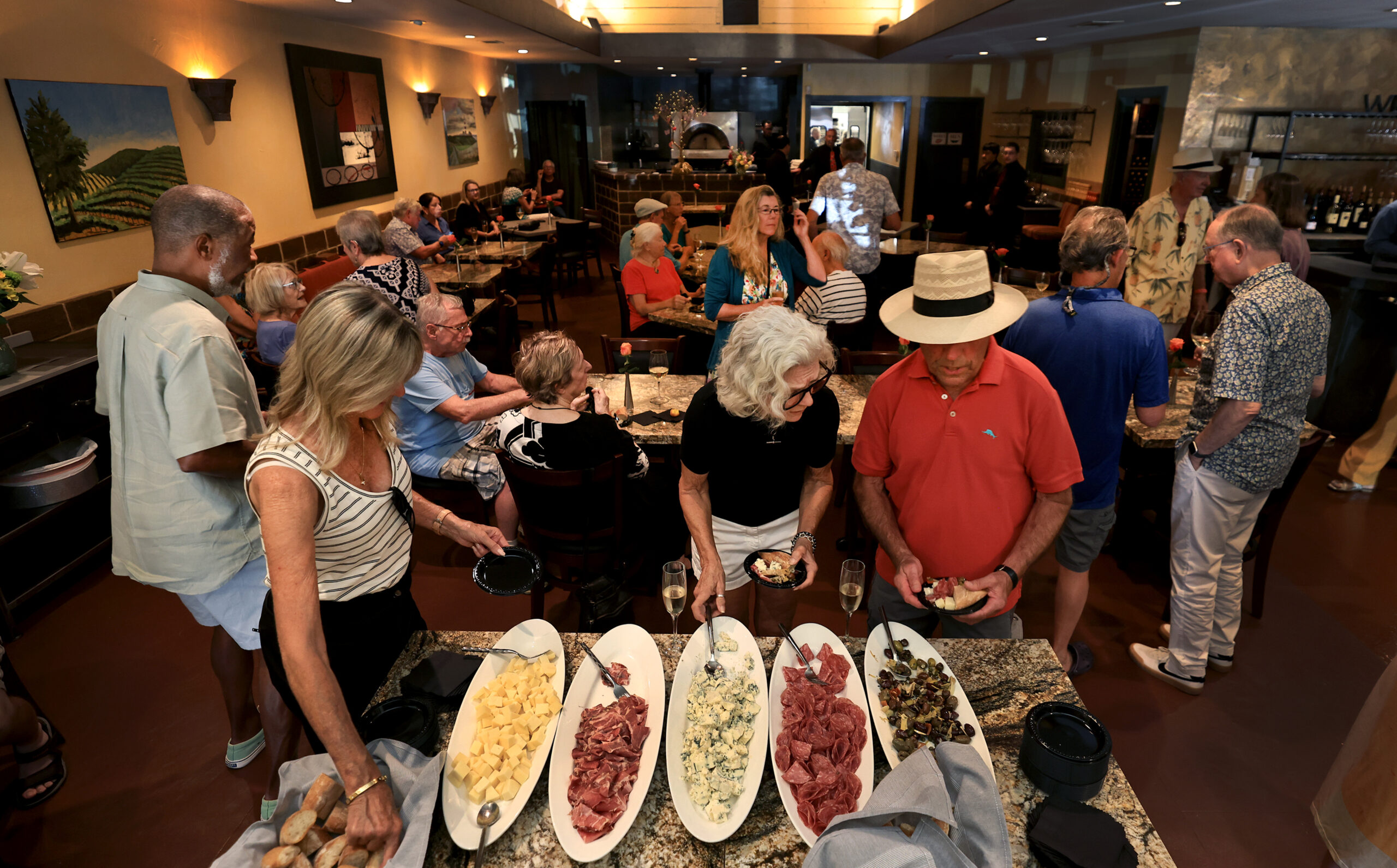 Guests crowd Baci Cafe and Wine Bar at the reopening of the restaurant