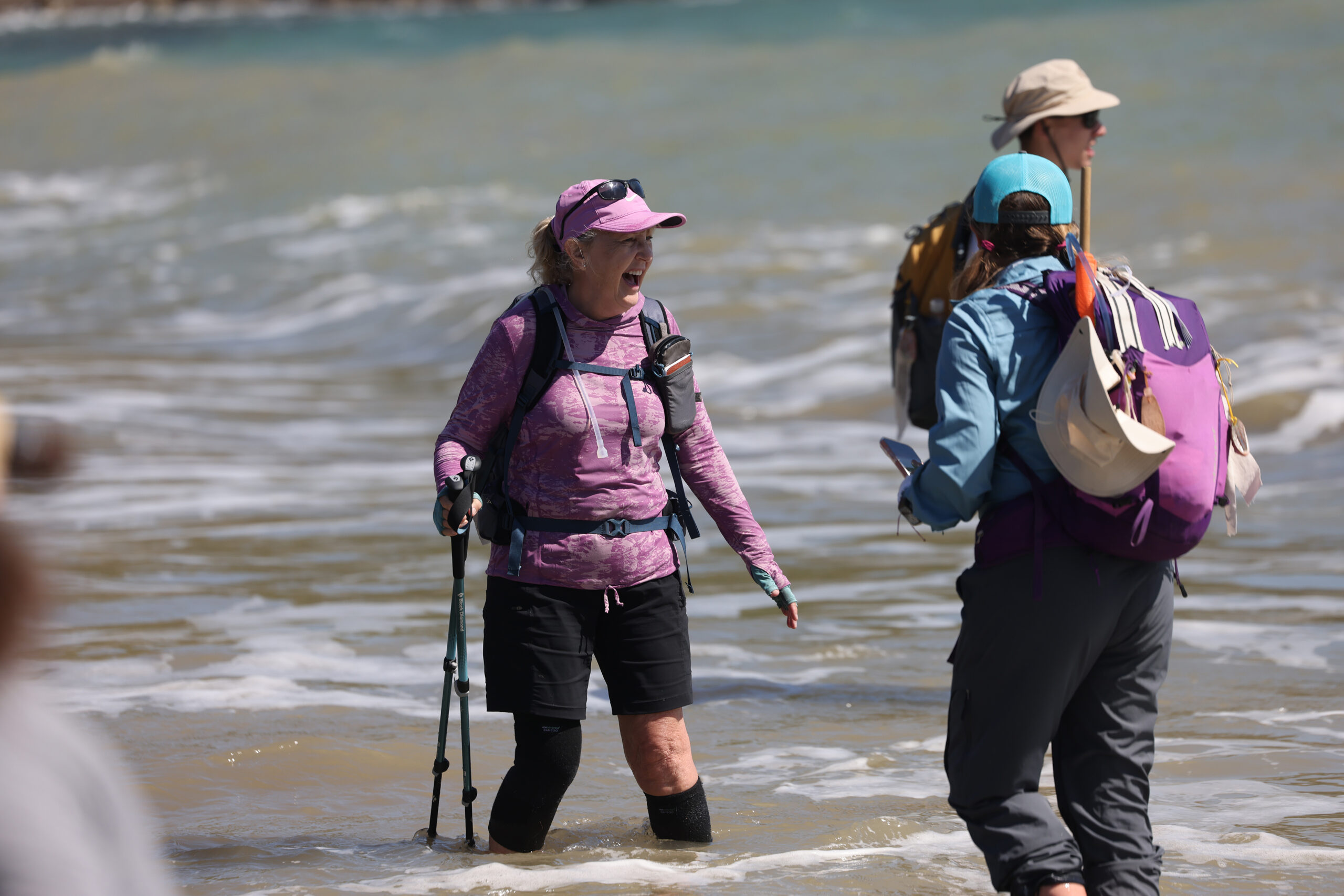 Camino de Sonoma hikers cool their feet in the ocean in Fort Ross Tuesday, May 19, 2026. (Beth Schlanker / The Press Democrat)