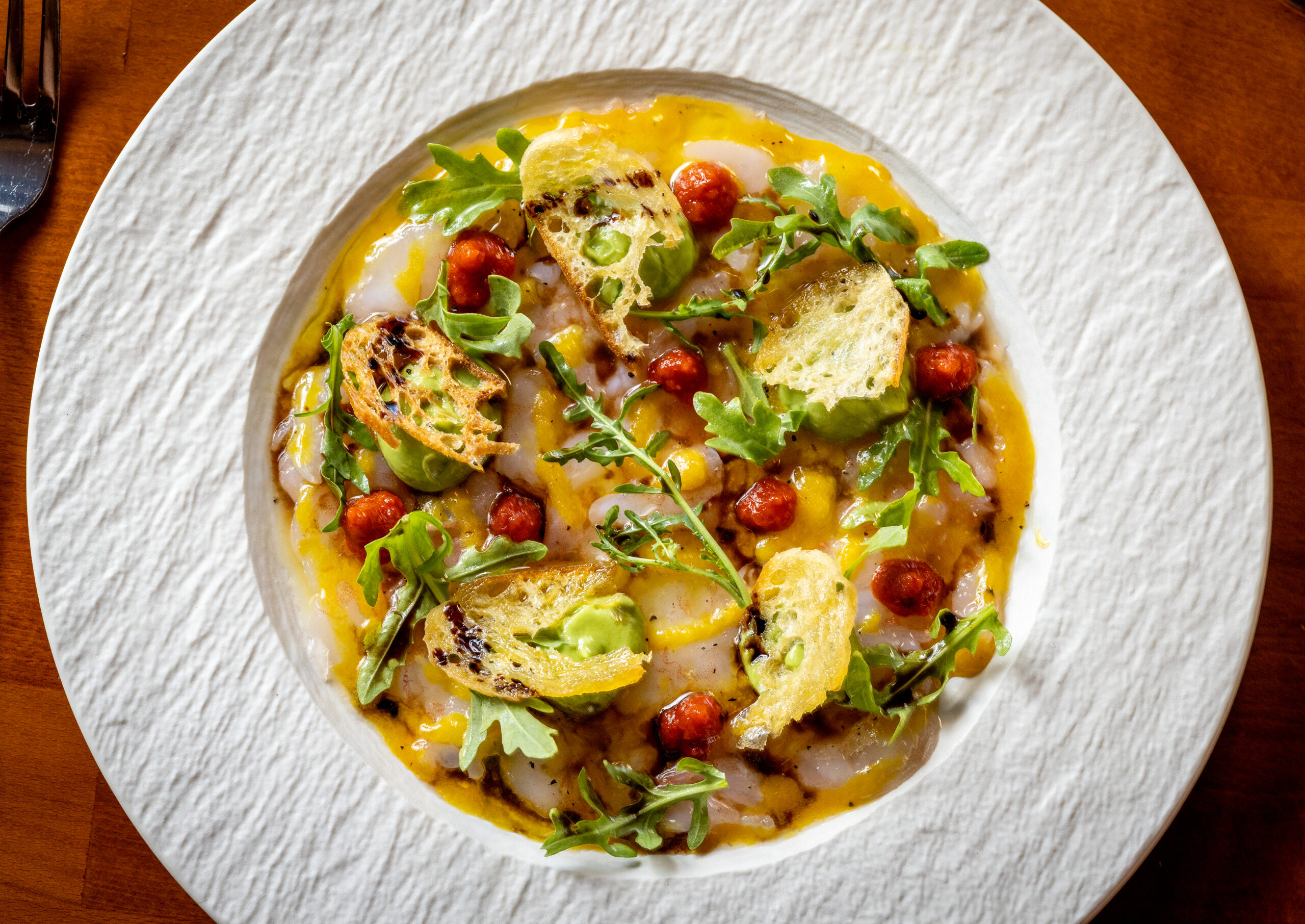 Carpaccio di Bamberi Rosso with raw shrimp in Sicilian chile, passion vinaigrette, avocado puree, croutons and arugula from Capriciano Osteria Thursday, July 30, 2026 in Santa Rosa. (John Burgess/The Press Democrat)