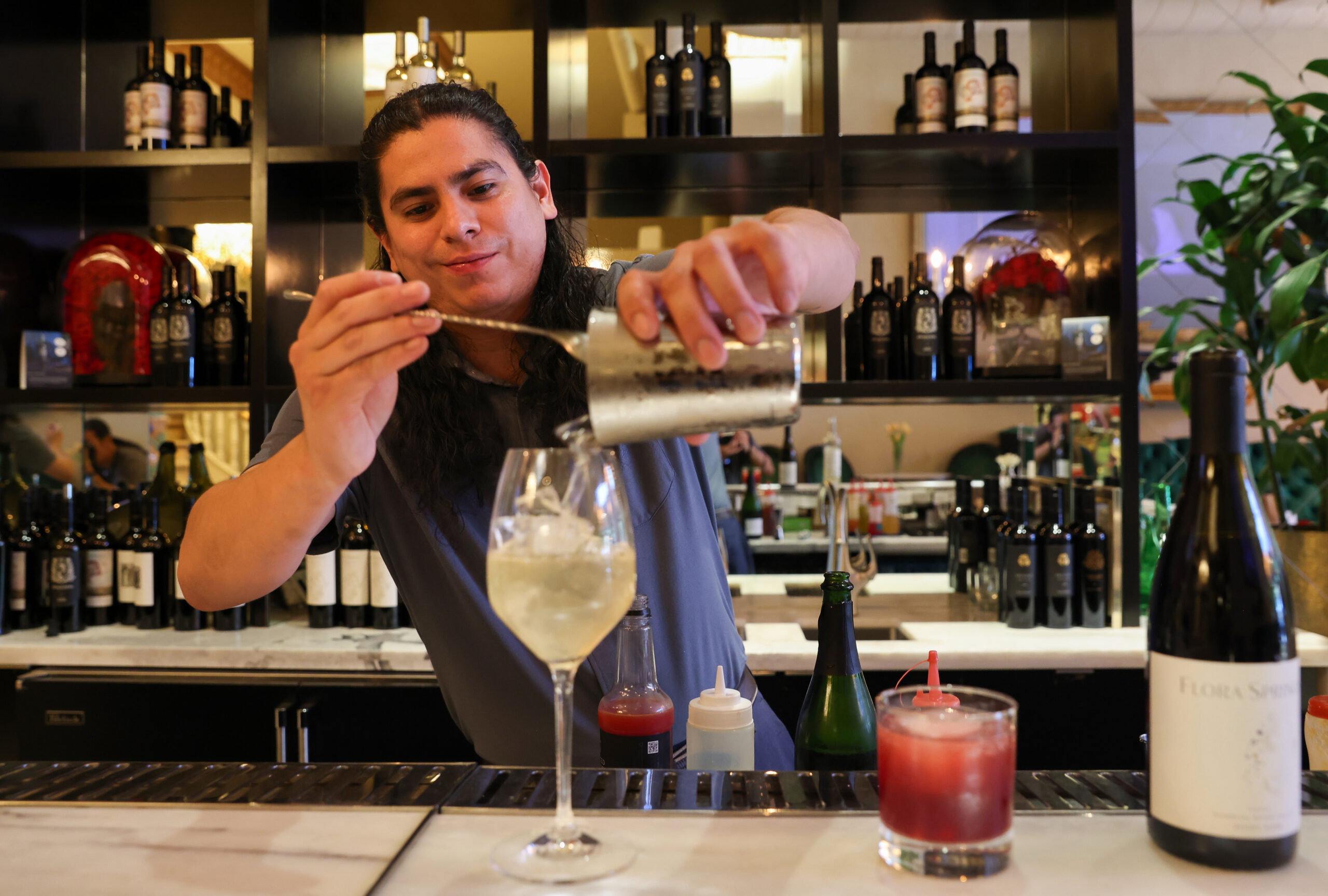 Pedro Acosta prepares The Napa 75 cocktail at Flora Springs Wine Lounge in Napa on Friday, August 21, 2026. (Christopher Chung/The Press Democrat)