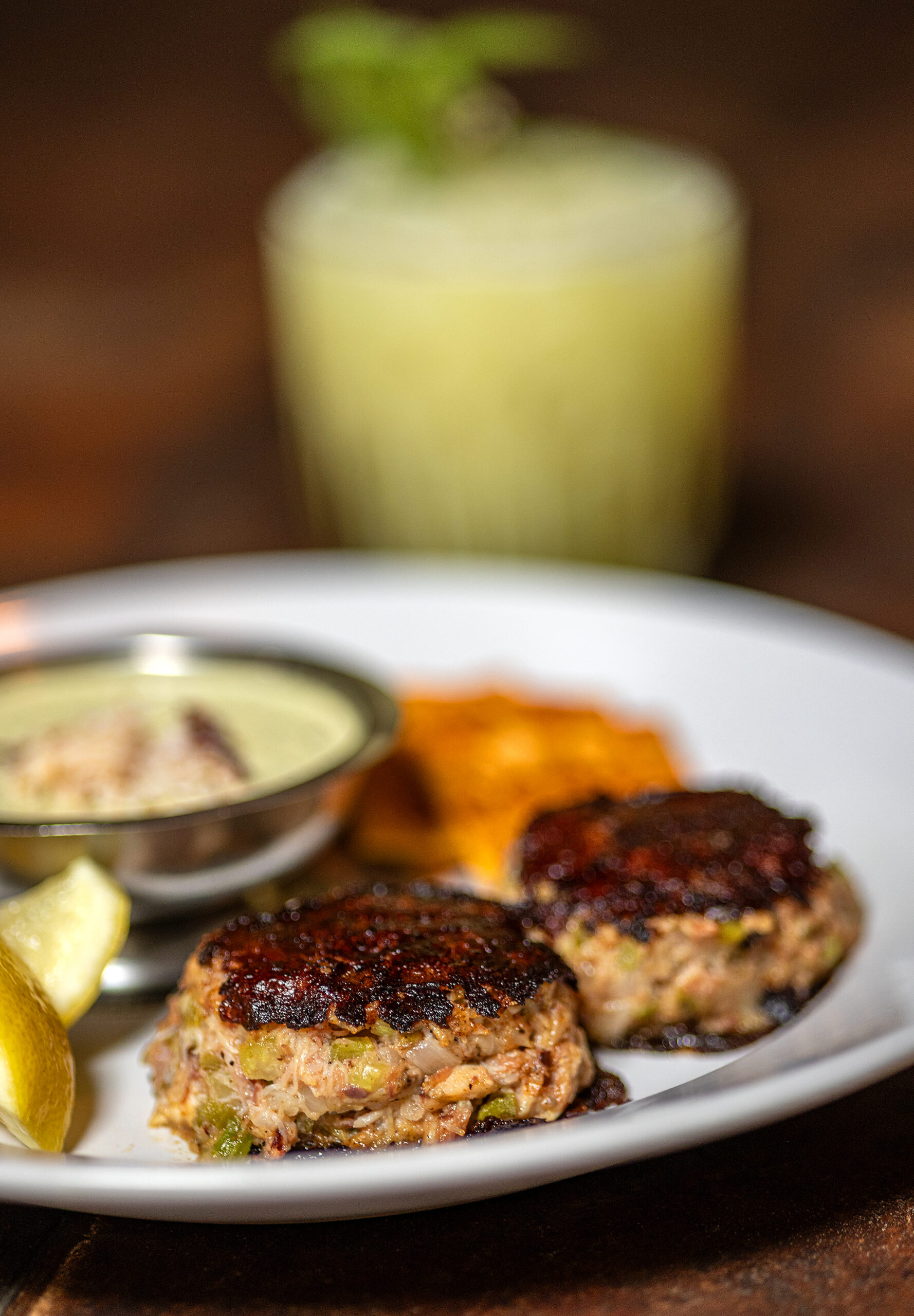 Grilled Crab Cakes with ham hock, reinvigorating sauce, and soda crackers from Lo & Behold 
