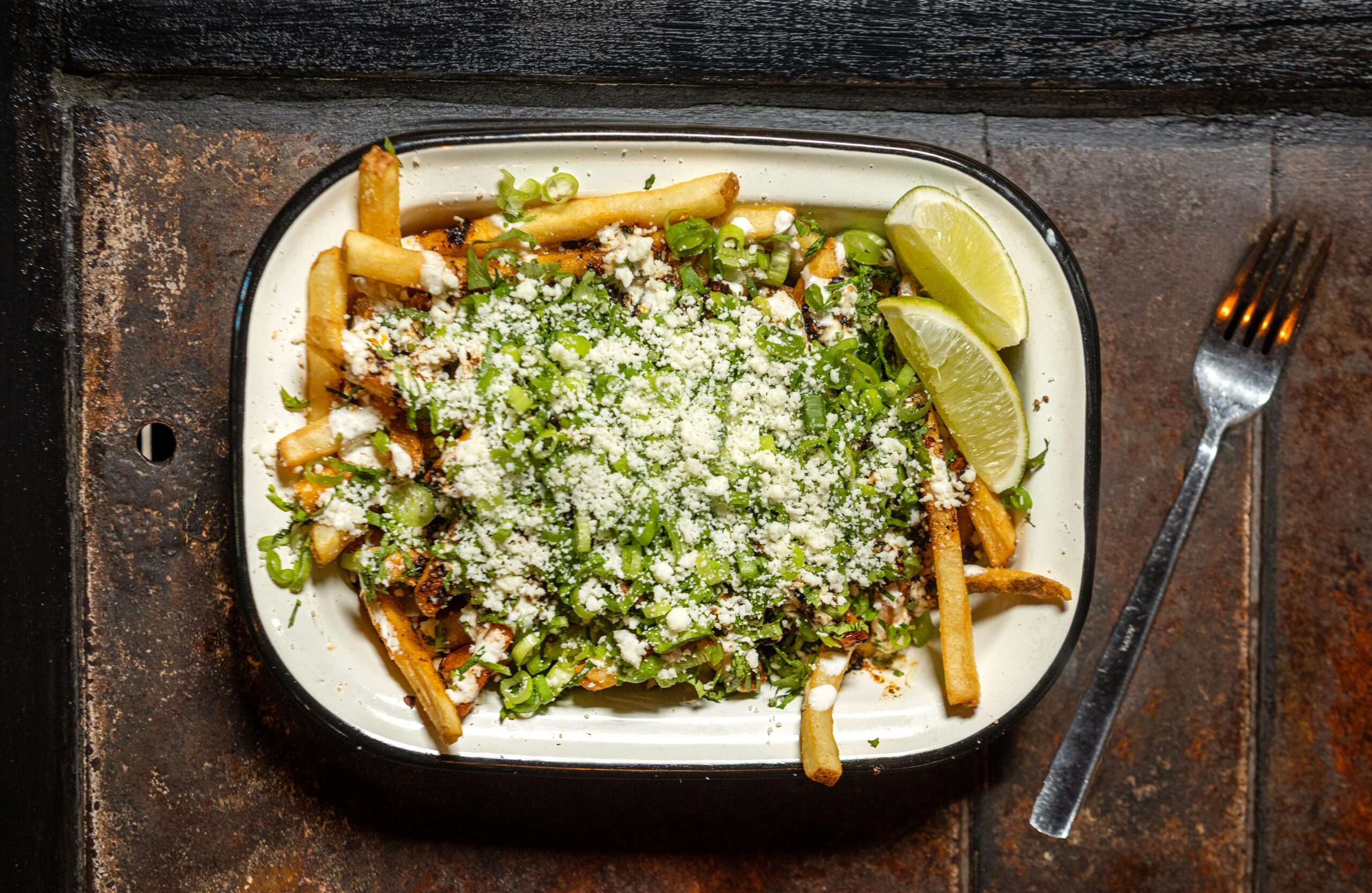 Salsa Macha Fries with cotija cheese, cilatntro, and lime cream from Lo & Behold Monday, Aug. 3, 2026 in Healdsburg. (John Burgess/The Press Democrat)