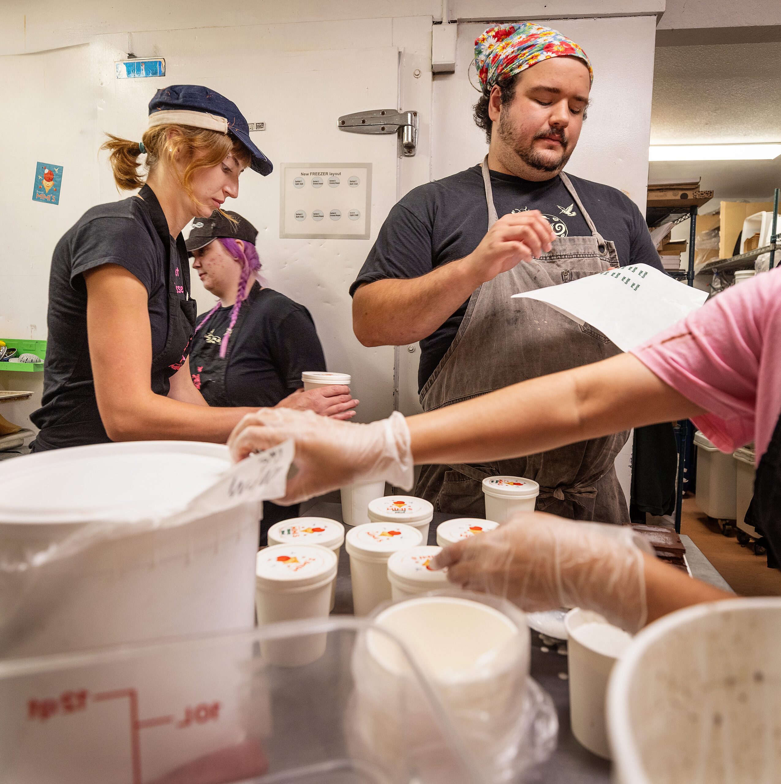 Manager Carter Olson, son of Screamin’ Mimi’s owner Maraline Olson, packages pints of ice cream with the crew in the back of their Sebastopol store Tuesday, Aug. 11, 2026. (John Burgess/The Press Democrat)