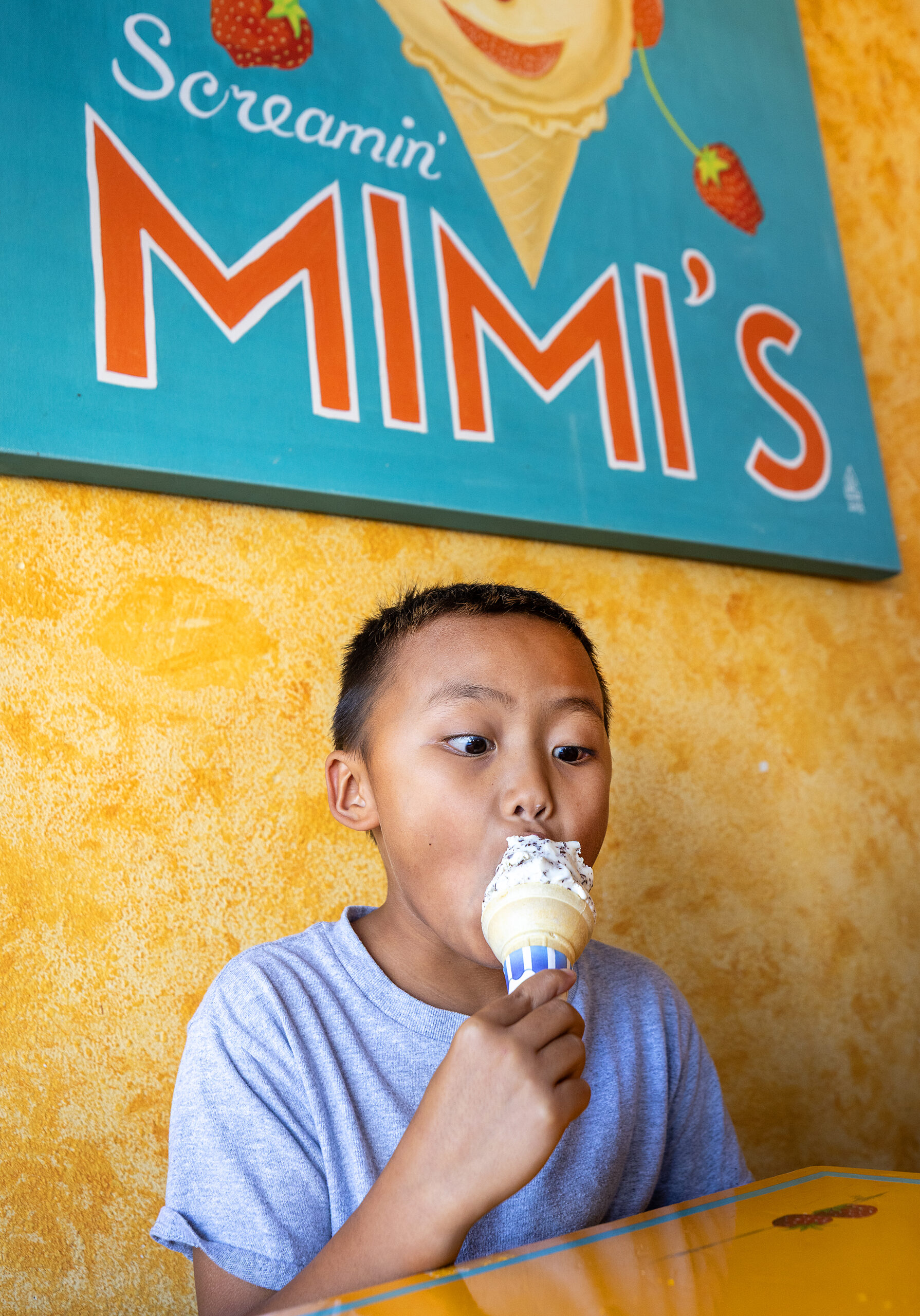 A child digs into his Galaxy ice cream cone at Screamin’ Mimi’s