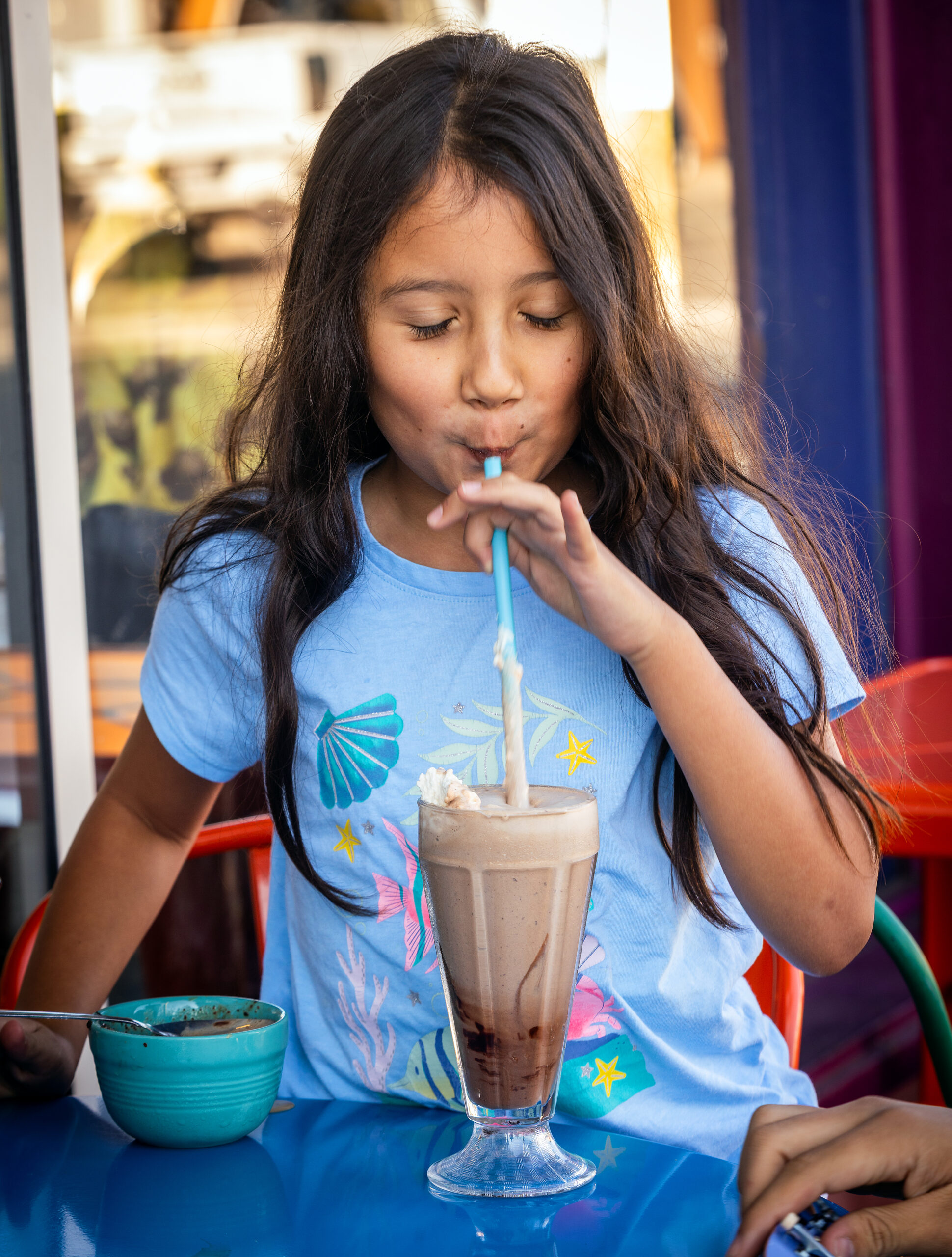 A child enjoys a chocolate shake at Screamin’ Mimi’s