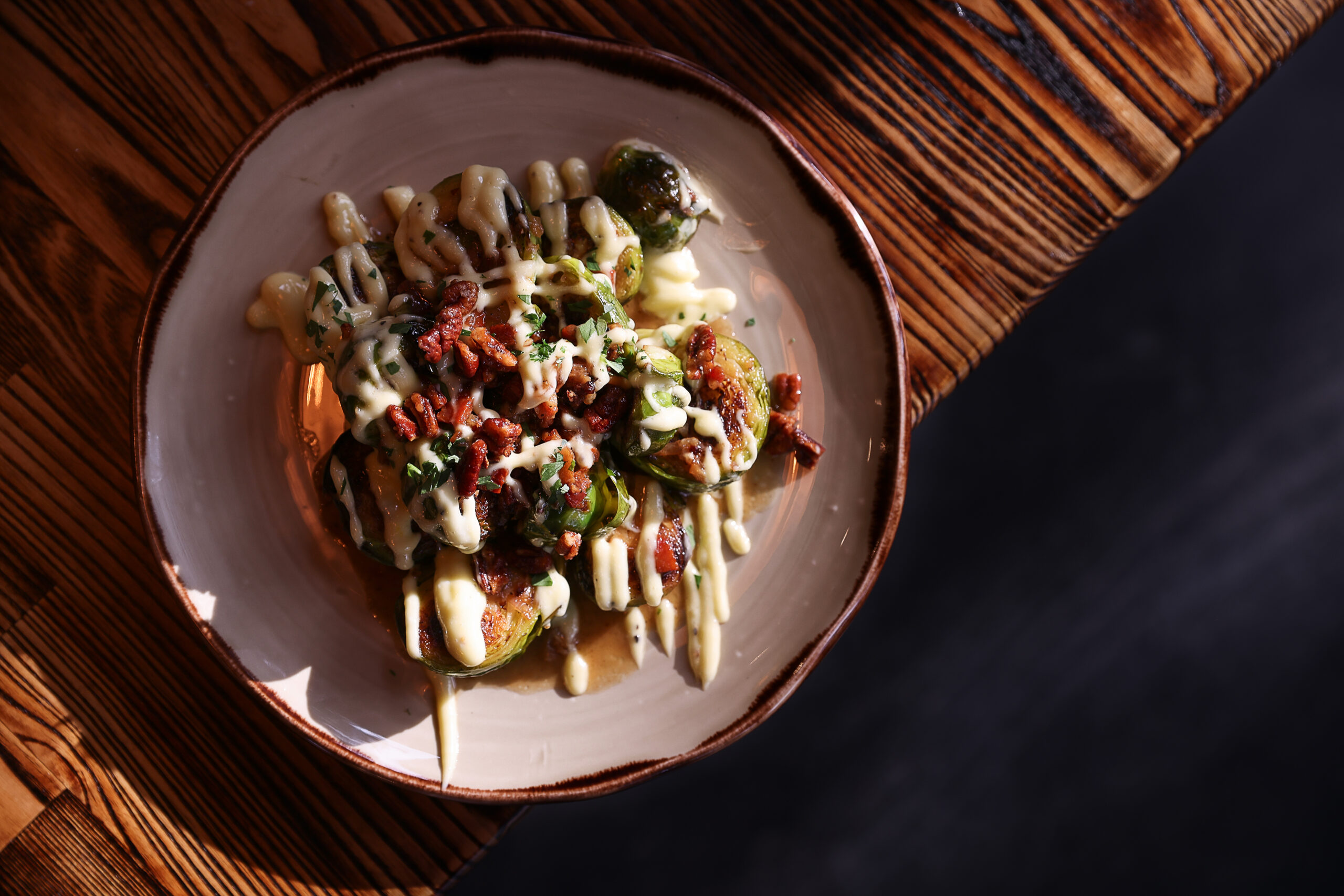 Brussels Sprouts with Candied Pecans served at The Porch Kitchen in Sebastopol on Thursday, August 20, 2026. (Christopher Chung/The Press Democrat)
